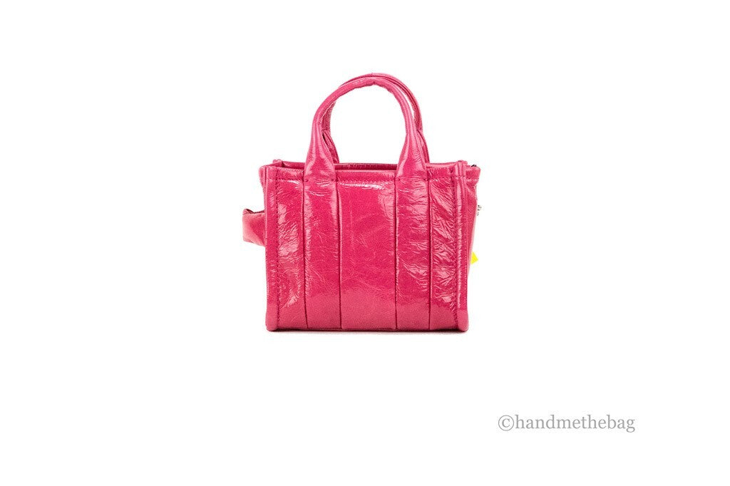 Discover the Marc Jacobs Shiny Crinkle Micro Tote, a magenta patent leather masterpiece that embodies elegance and sophistication, perfect for the discerning individual.