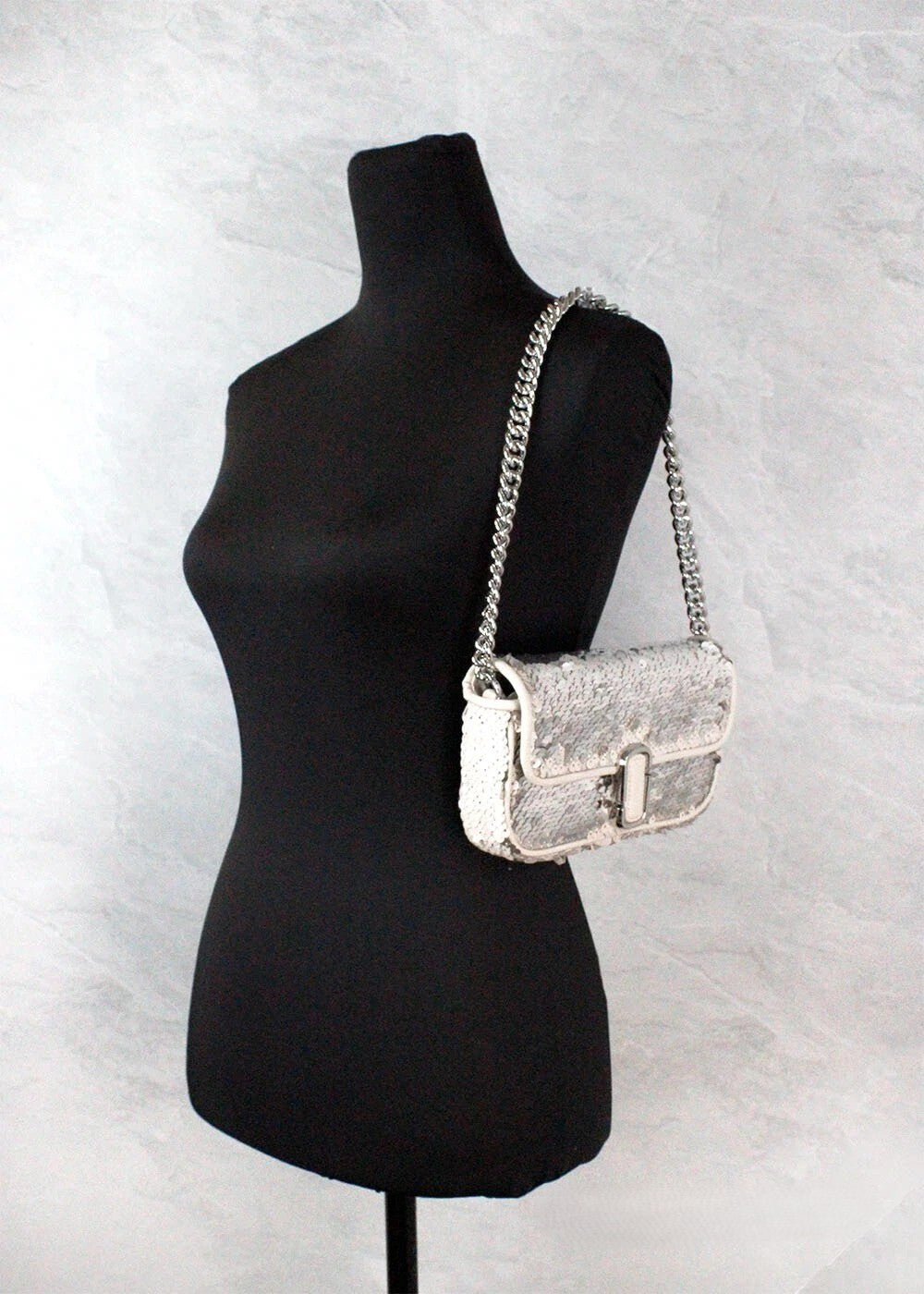 Discover the Marc Jacobs Mini J Marc Shoulder Bag, a cream sequined masterpiece that embodies elegance and sophistication for every occasion.