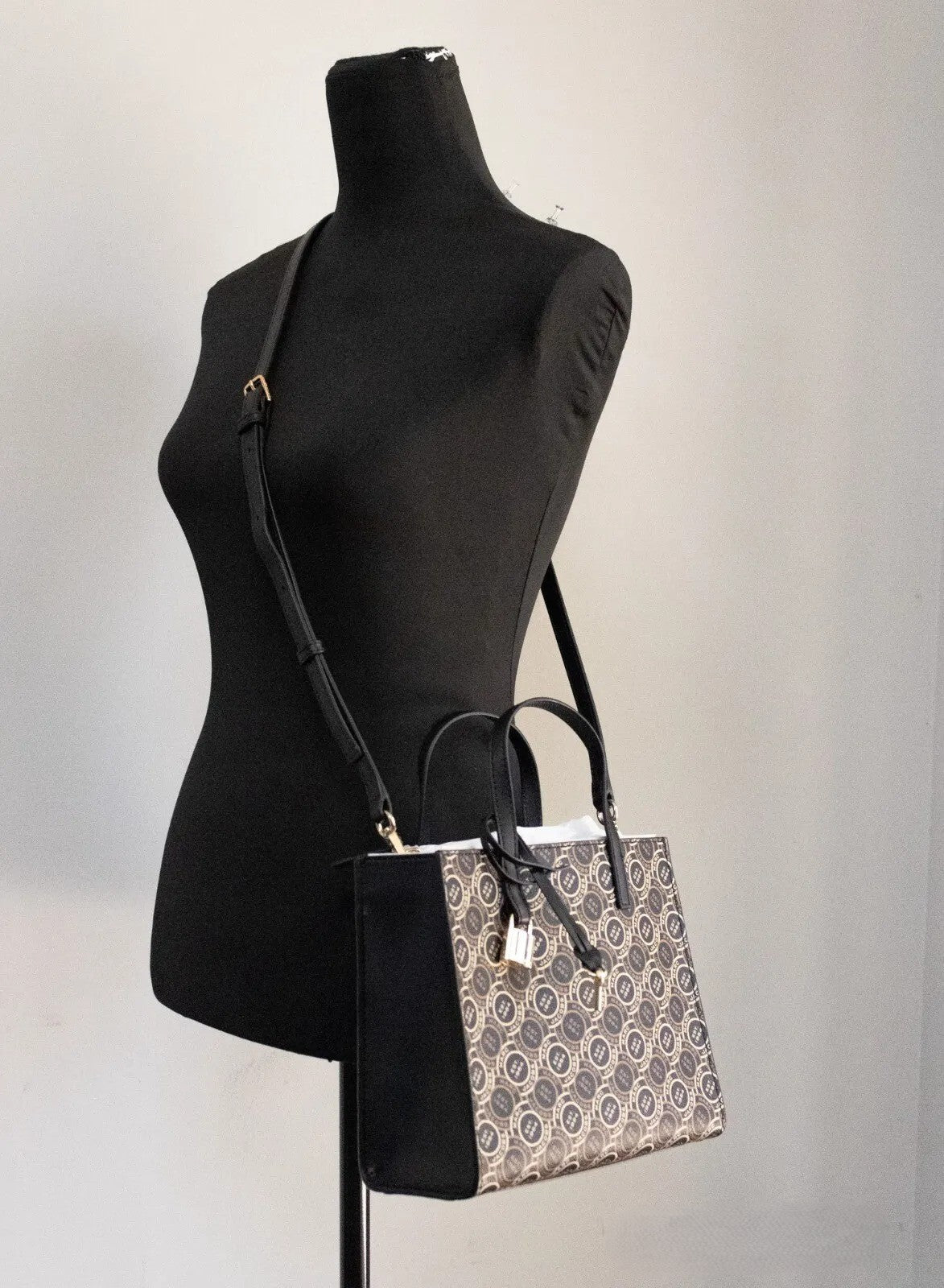Discover the Marc Jacobs Mini Grind Signet Printed Leather Crossbody Tote, an exquisite blend of luxurious design and impeccable craftsmanship, perfect for any sophisticated occasion.