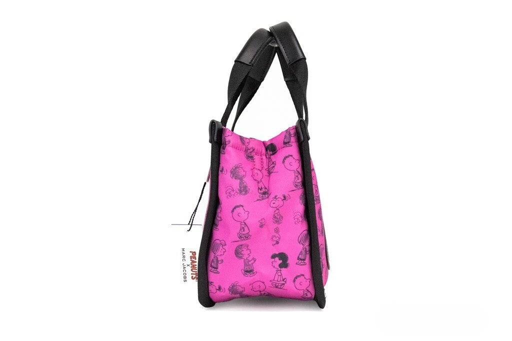 Elevate your style with the Marc Jacobs X Peanuts Mini Fuchsia Fedora Tote, a limited edition masterpiece in durable nylon, blending playful charm with luxurious sophistication.