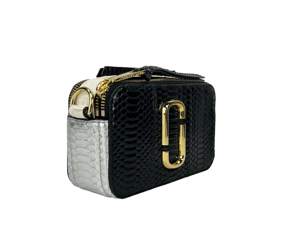 Elevate your style with the Marc Jacobs The Snapshot Snake Skin Crossbody Bag, crafted from luxurious calfskin leather, embodying sophistication and modern elegance for any occasion.