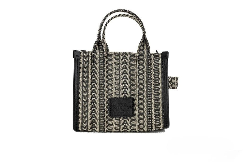 Discover the Marc Jacobs The Monogram Beige Mini Tote, a luxurious woven jacquard canvas handbag that embodies sophistication and versatility for every occasion.