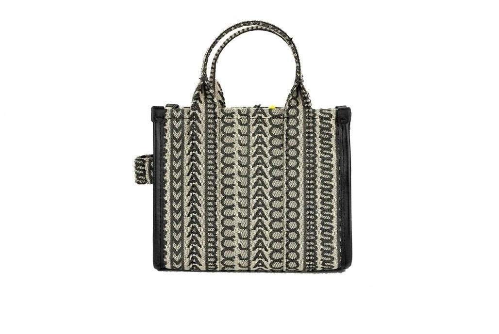 Elevate your style with the Marc Jacobs Monogram Beige Mini Tote, a luxurious woven jacquard canvas handbag that embodies sophistication and versatility for any occasion.