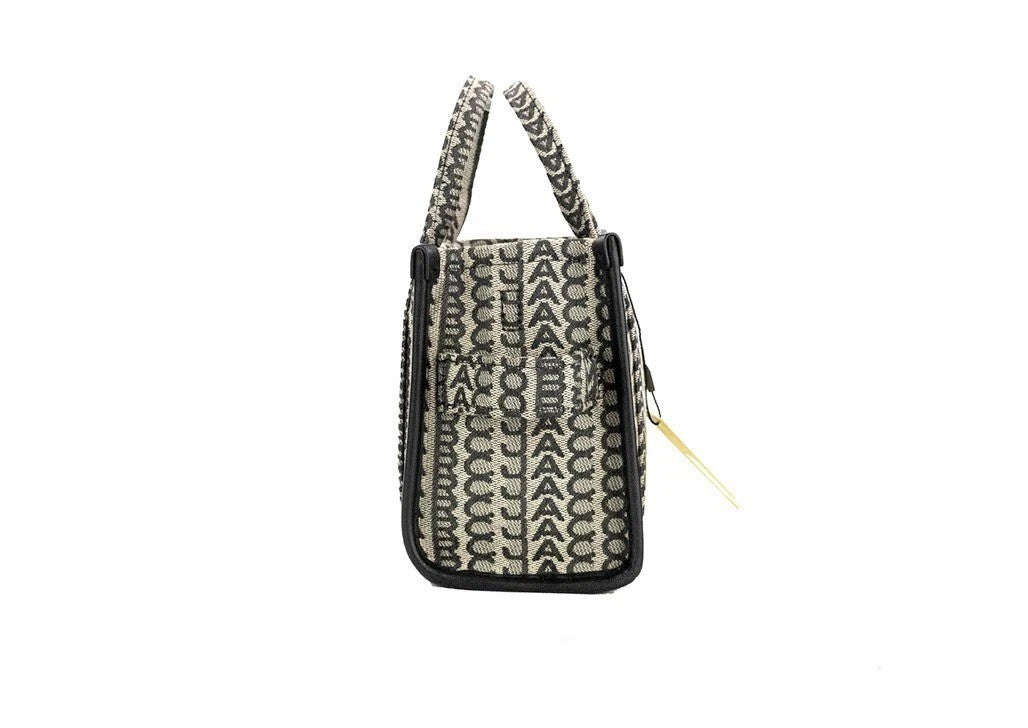 Discover the Marc Jacobs The Monogram Beige Mini Tote, a luxurious woven jacquard canvas handbag that embodies sophistication and versatility for the discerning individual.