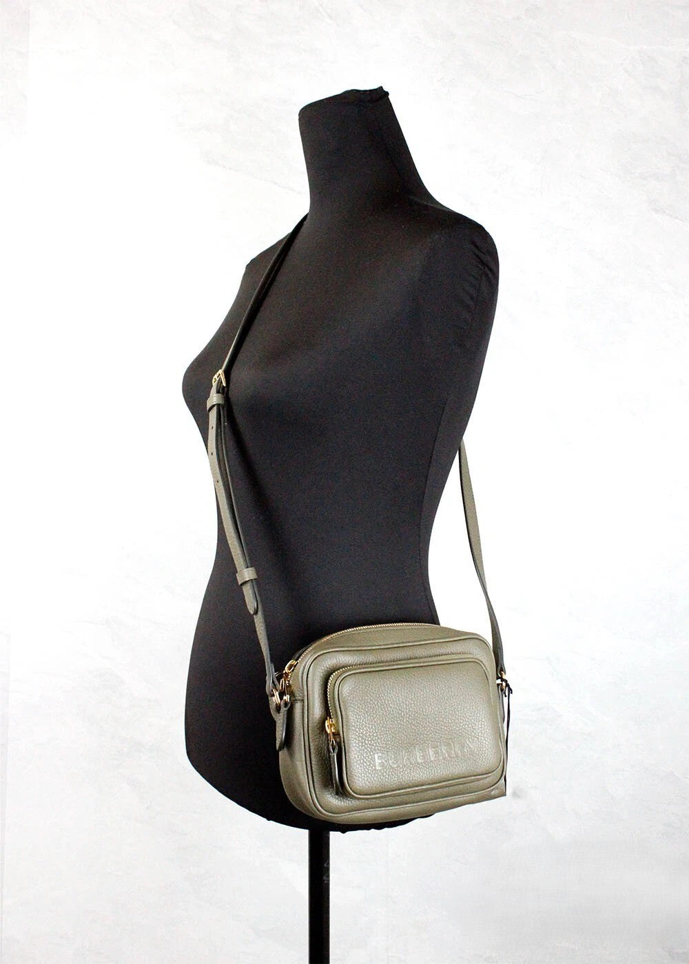 Elevate your style with the Burberry Small Branded Dark Fern Green Grainy Leather Camera Crossbody Bag, a fusion of exquisite craftsmanship and timeless elegance.