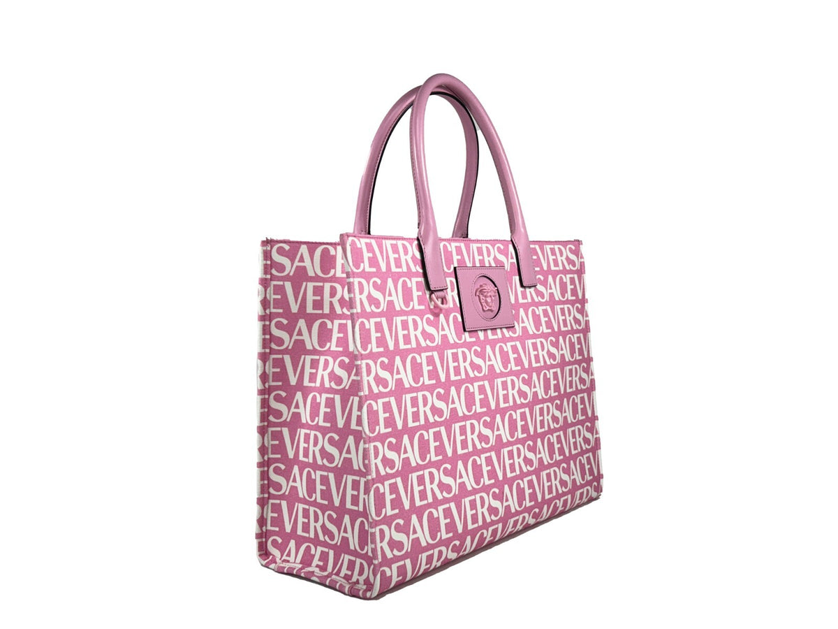 Elevate your style with the Versace Medusa Large Canvas Tote Bag in baby pink, a masterpiece of Italian craftsmanship that embodies luxury and sophistication.