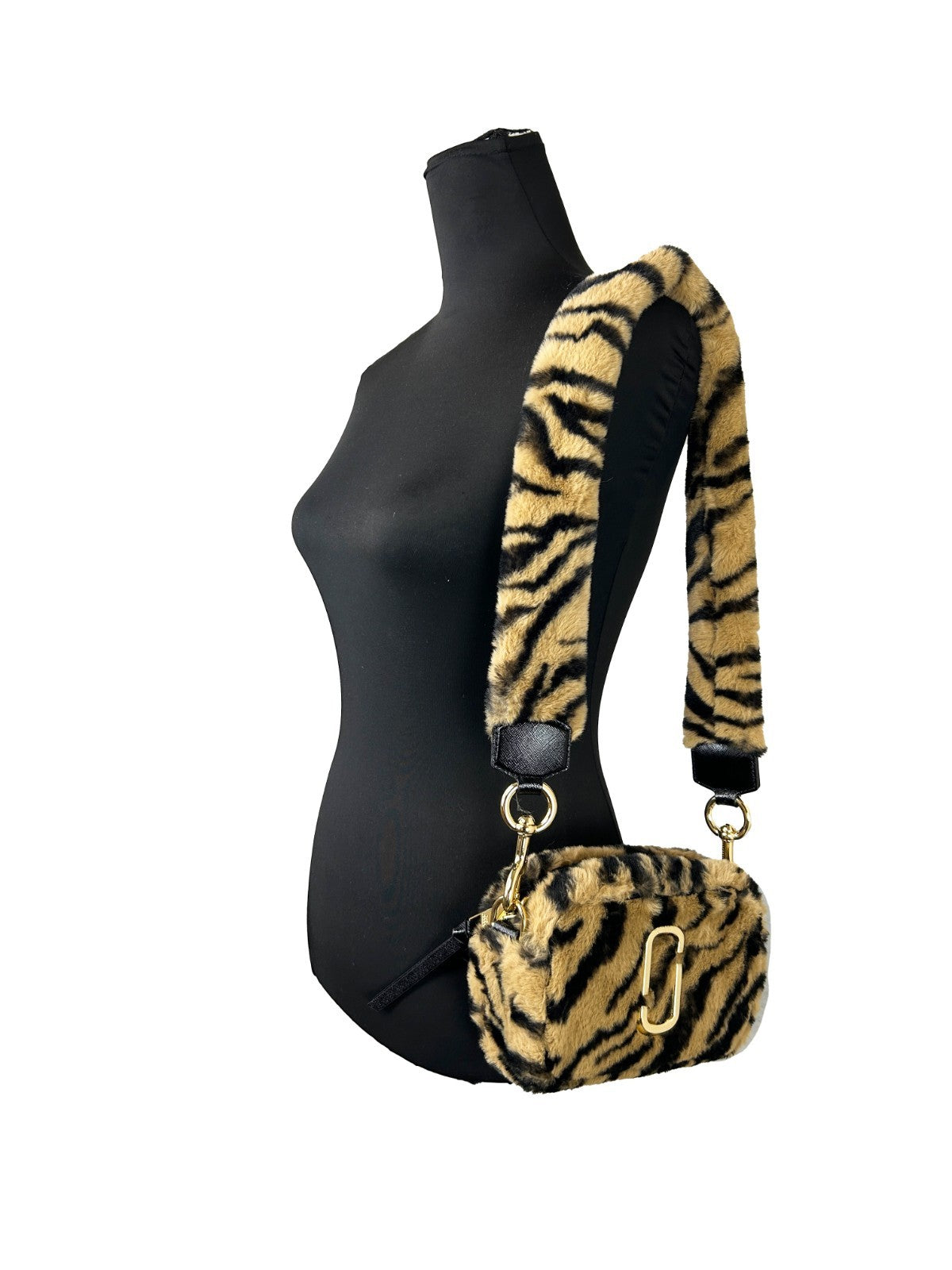 Elevate your allure with the Marc Jacobs The Snapshot Tiger Fur Crossbody Bag, a luxurious blend of faux fur and impeccable craftsmanship, perfect for any sophisticated occasion.