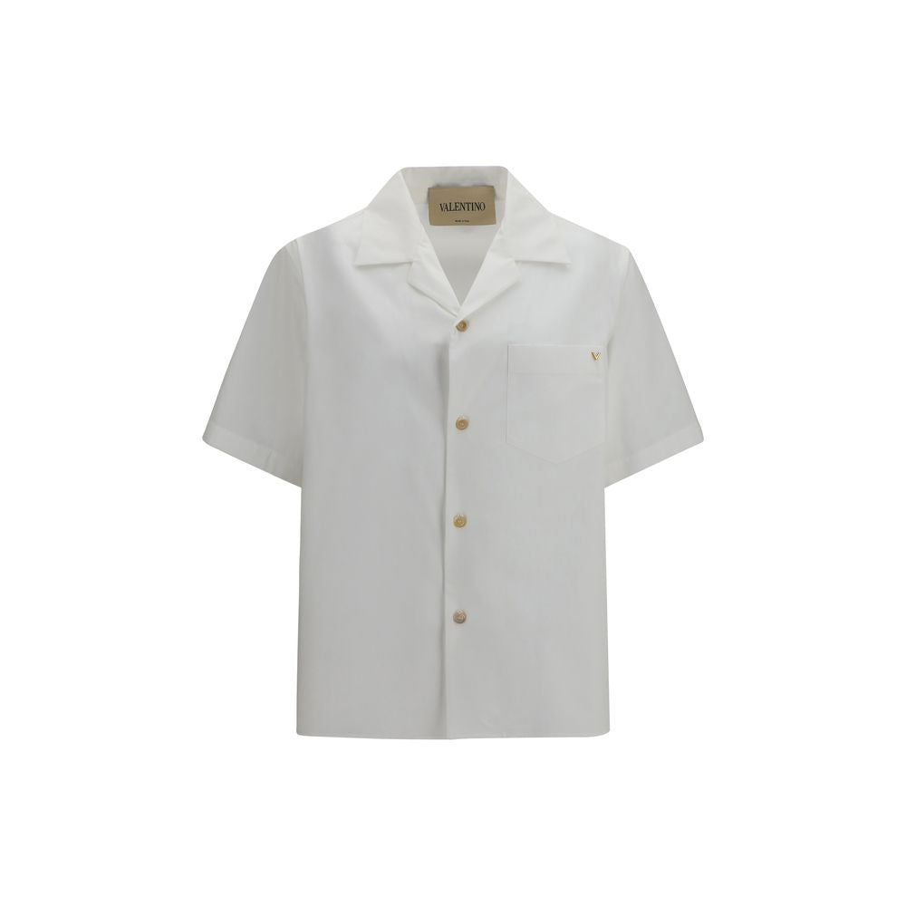Discover the Valentino White Cotton Shortsleeve Shirt, a masterpiece of craftsmanship and elegance, perfect for those who appreciate refined luxury and contemporary style.