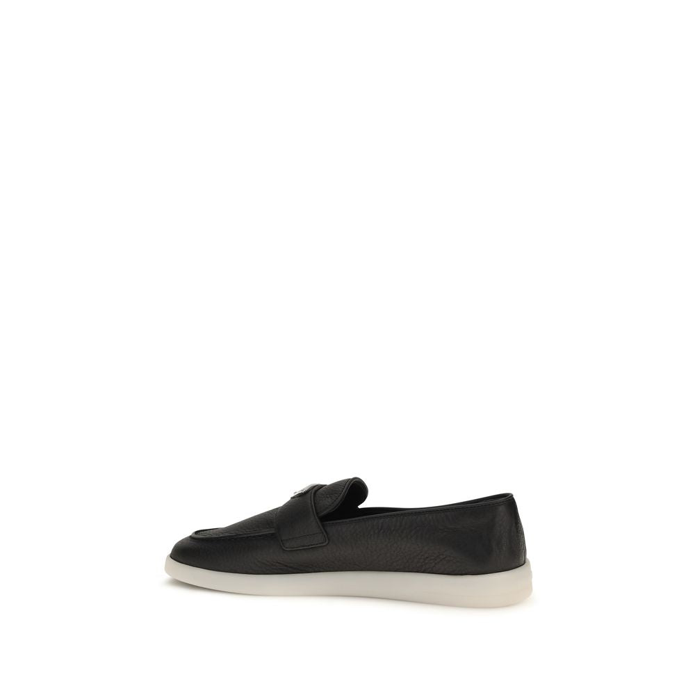 Indulge in the exquisite Prada Black Calf Leather Bos Taurus Slip-On Loafers, where Italian craftsmanship meets luxurious comfort, perfect for the discerning individual.