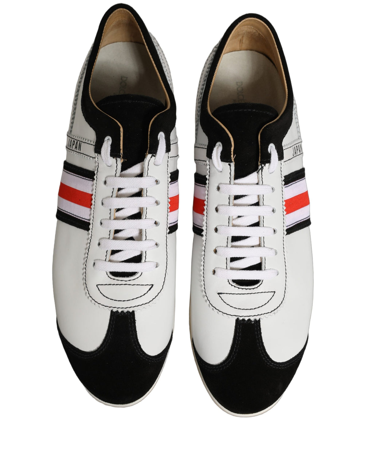 Experience the allure of Dolce & Gabbana's Black White Leather Suede Low Top Sneakers, where exquisite craftsmanship meets luxurious style, perfect for the discerning individual.