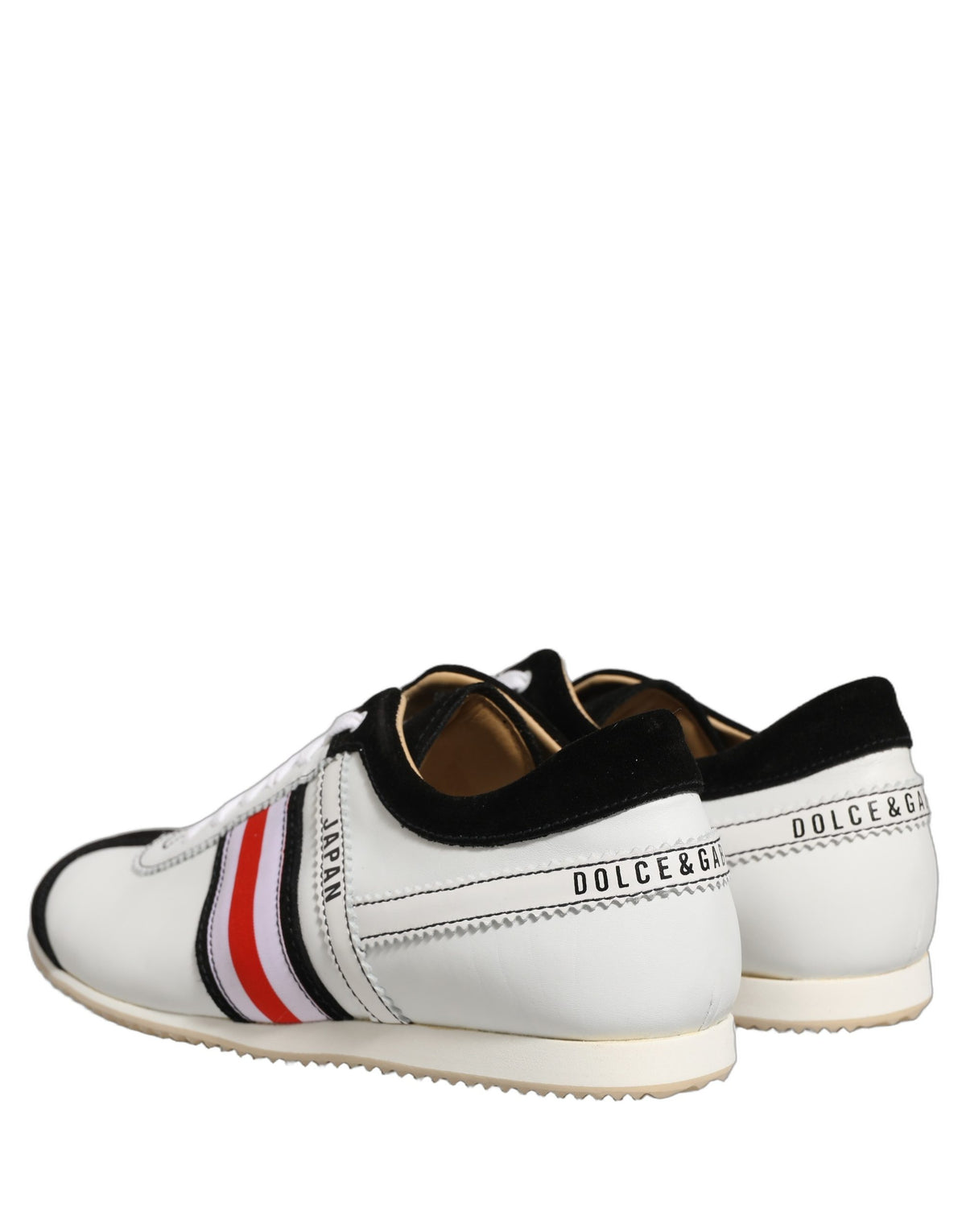 Indulge in the exquisite craftsmanship of Dolce & Gabbana's Black White Leather Suede Low Top Sneakers, where luxury meets timeless elegance for the discerning individual.