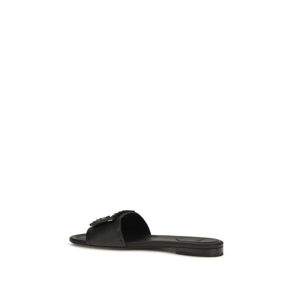 Experience the allure of Fendi's Black Calf Leather Bos Taurus Flat Sandals, where exquisite craftsmanship meets contemporary elegance, redefining luxury for the discerning.