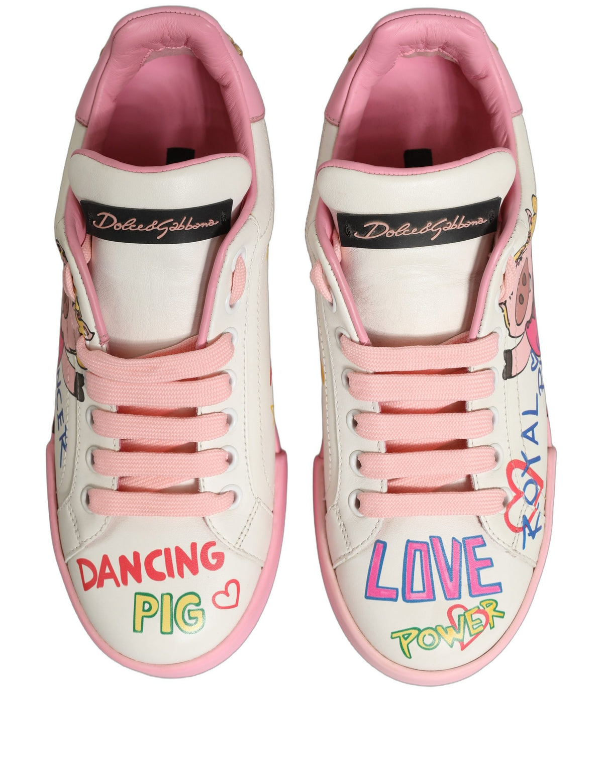 Step into the world of luxury with Dolce & Gabbana's White Pink Portofino Royal Pig Sneakers, crafted from exquisite calf leather, merging artistry with sophistication for the discerning individual.