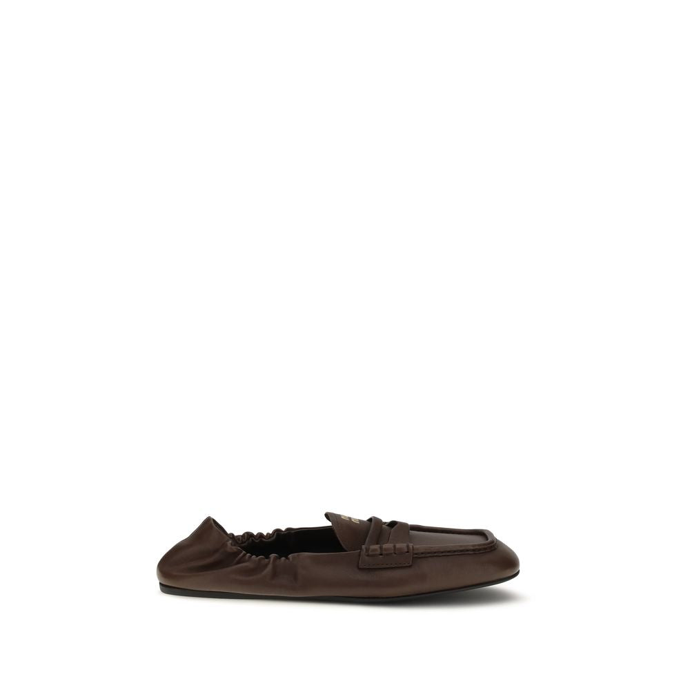 Experience the allure of Miu Miu's Brown Lamb Ovis Aries Slip-On Loafers, crafted from sumptuous nappa leather for timeless elegance and unparalleled sophistication.