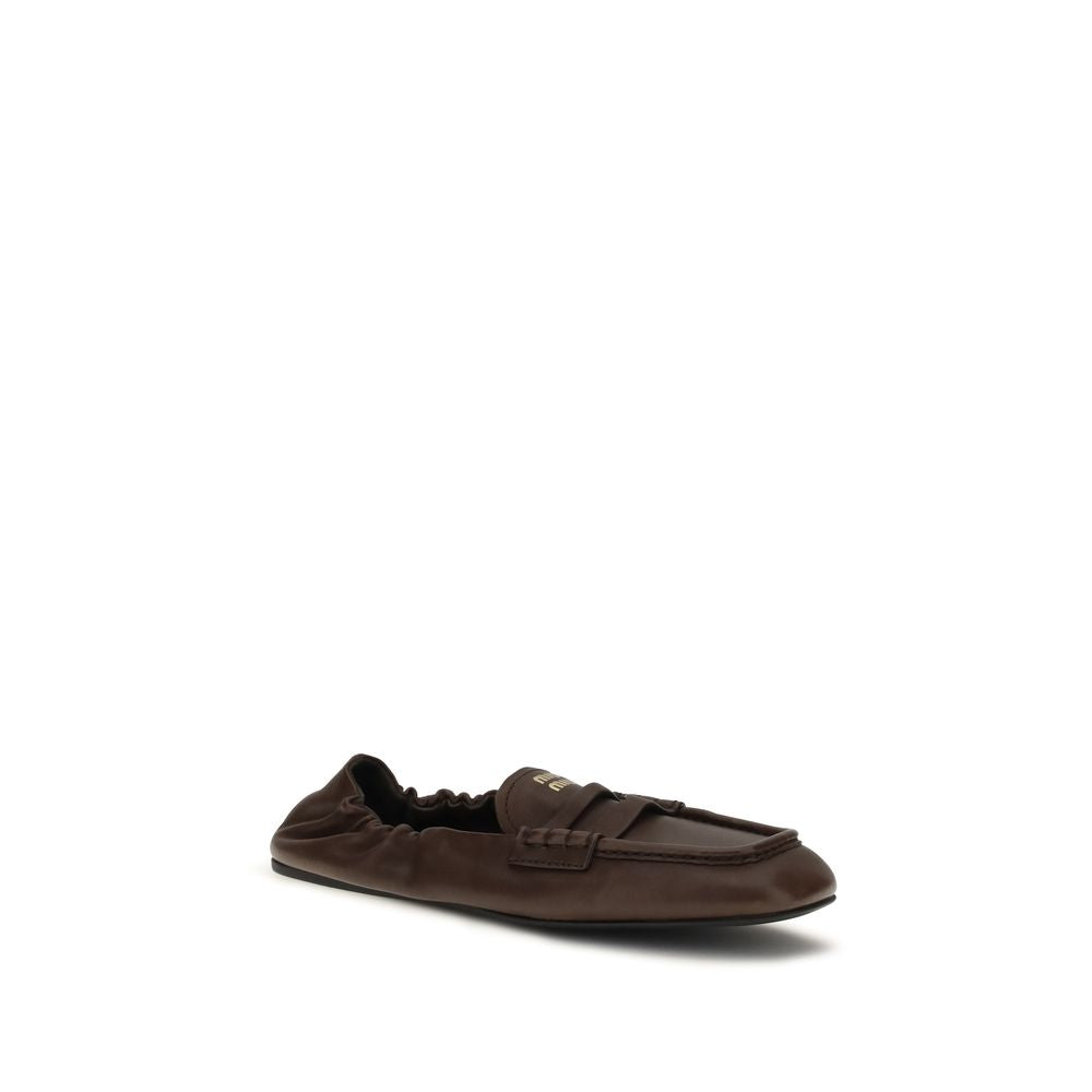 Elevate your style with Miu Miu's Brown Lamb Ovis Aries Slip-On Loafers, crafted from sumptuous nappa leather for timeless elegance and unmatched sophistication.