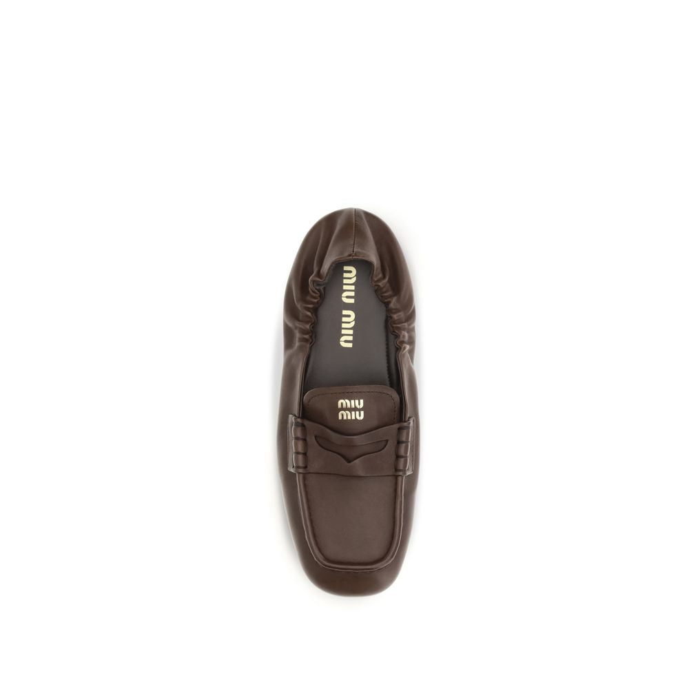 Elevate your style with Miu Miu's Brown Lamb Ovis Aries Slip-On Loafers, crafted from luxurious nappa leather for timeless elegance and effortless sophistication.