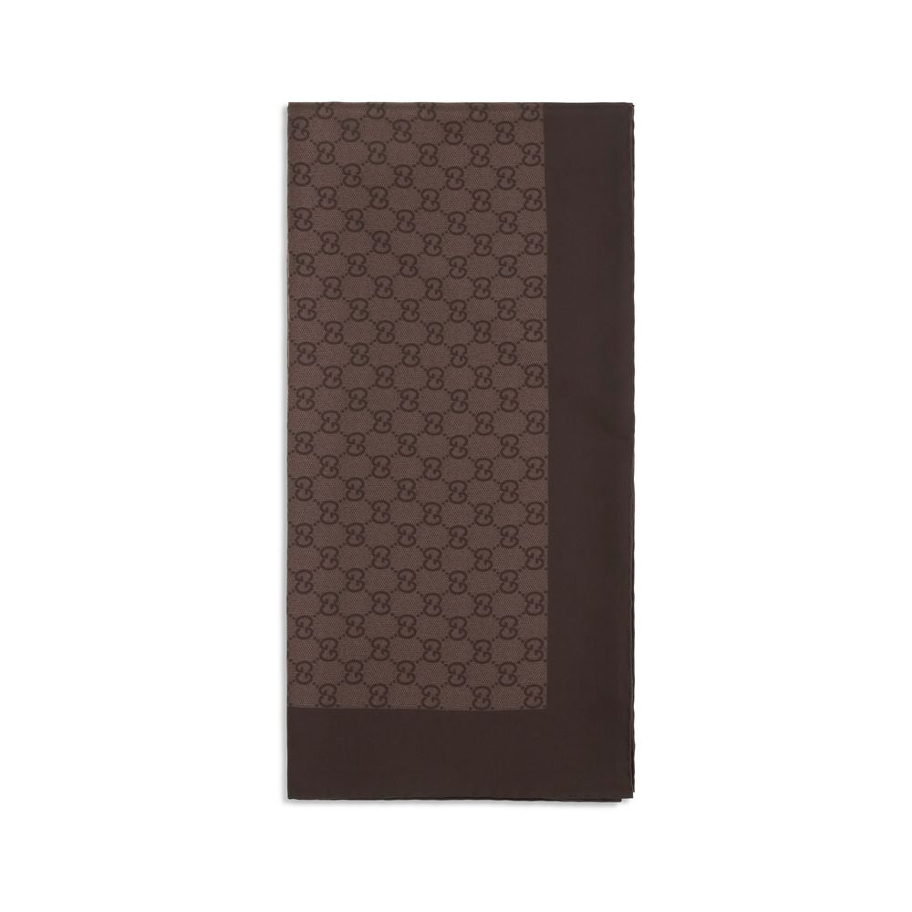 Indulge in the elegance of the Gucci Brown Silk Foulard, a luxurious accessory crafted from 100% silk, featuring an iconic GG pattern that elevates any ensemble.