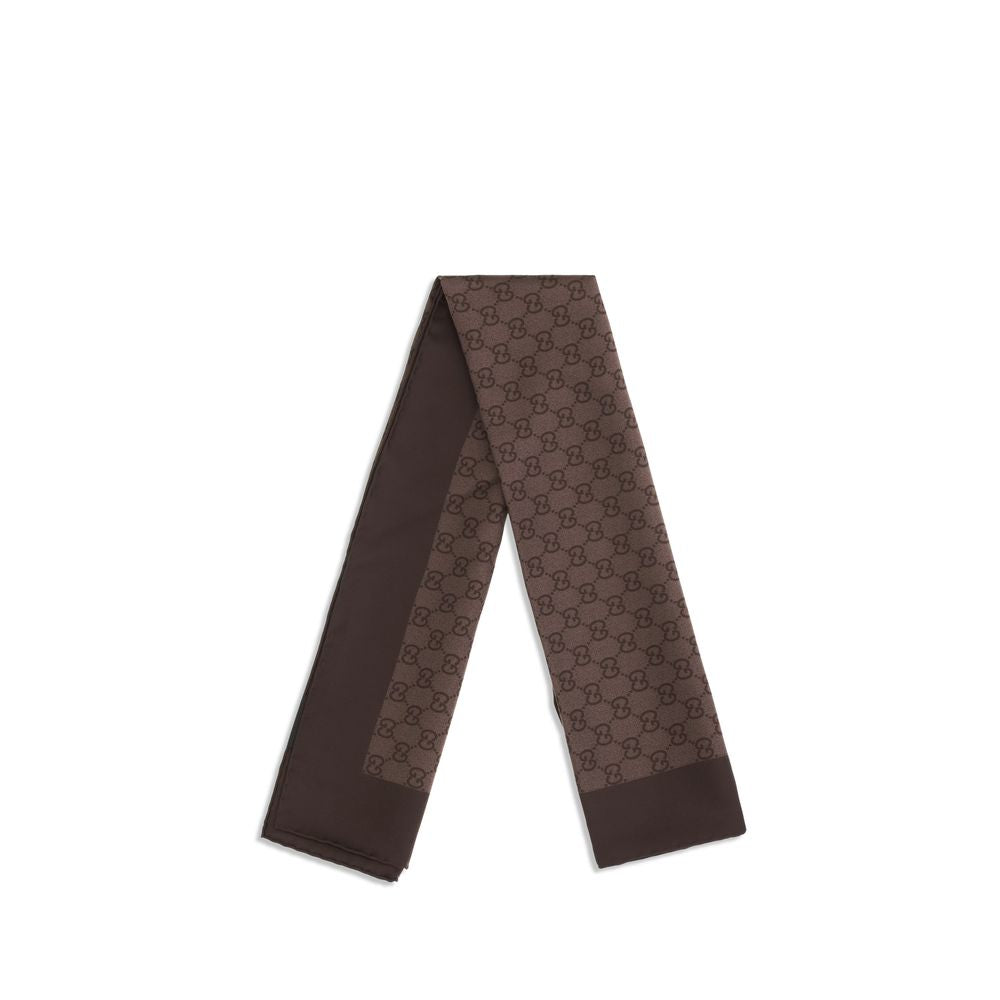 Indulge in the elegance of the Gucci Brown Silk Foulard, a timeless accessory crafted from luxurious silk, perfect for elevating any ensemble with its iconic GG pattern.
