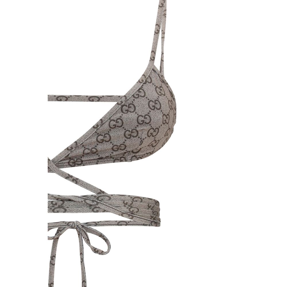 Indulge in the Gucci Beige Polyester Bikini, a luxurious blend of comfort and style, featuring an iconic GG print for the discerning individual seeking elegance by the water.