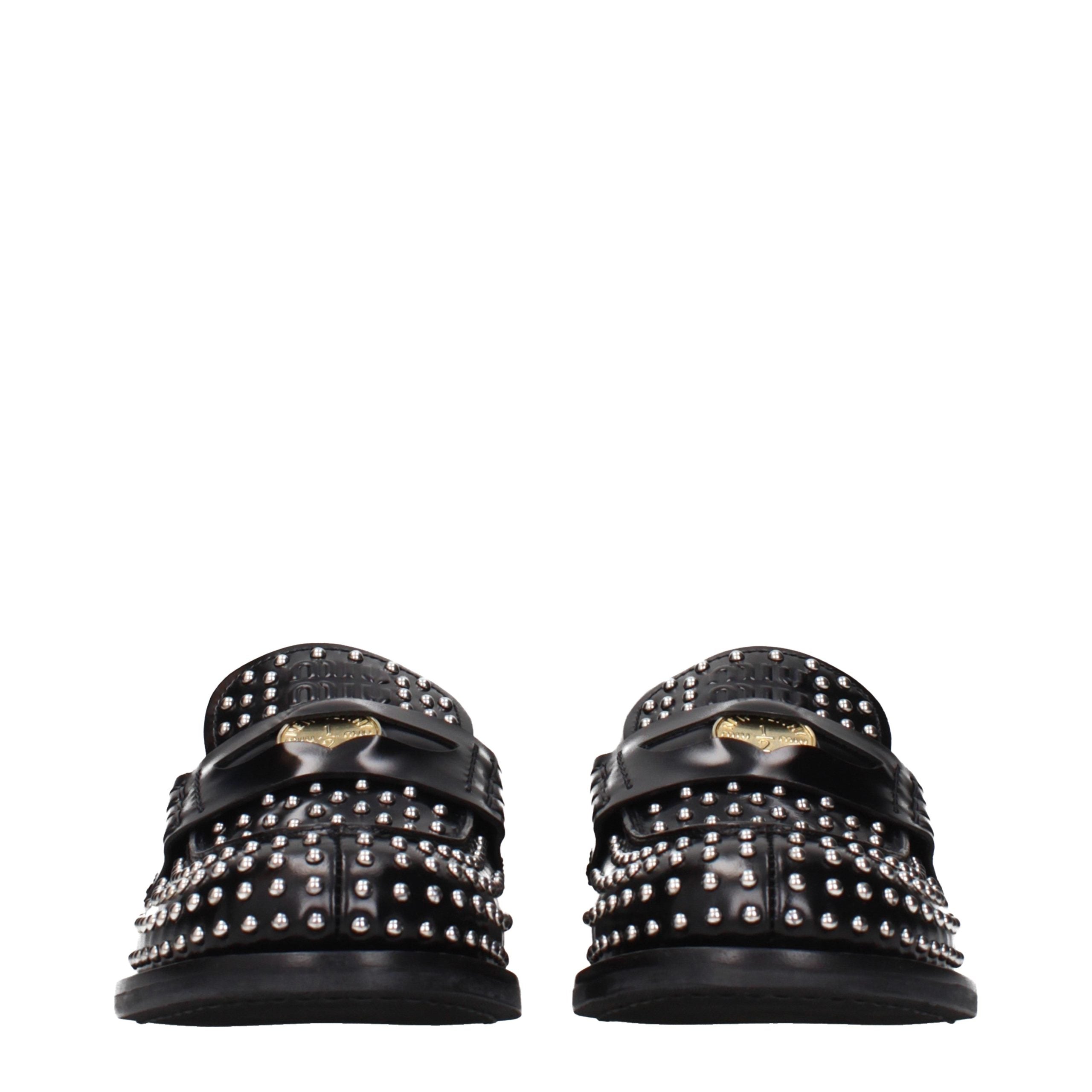 Elevate your style with Miu Miu Black Leather Slip-On Loafers, where exquisite craftsmanship meets timeless elegance, perfect for the discerning individual.