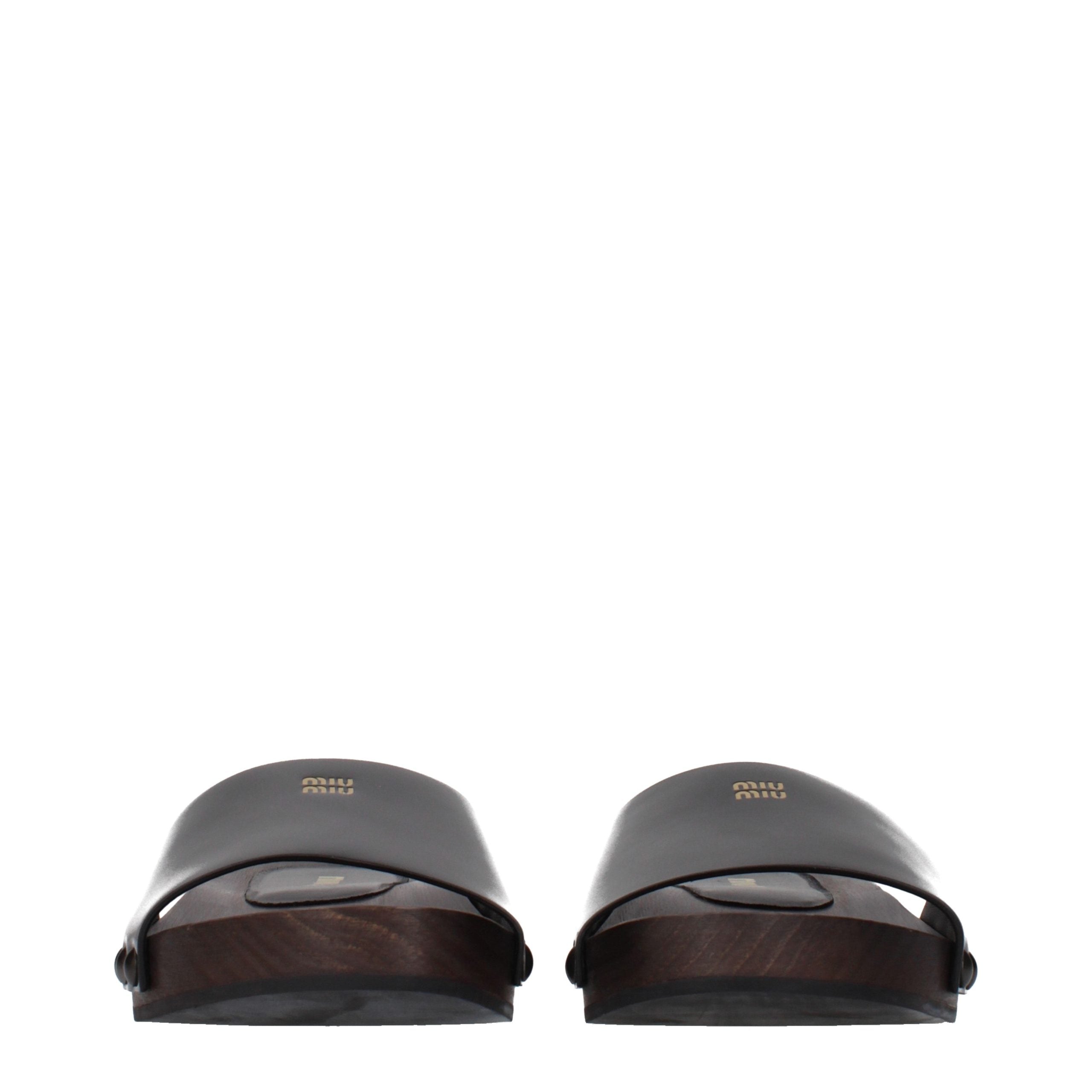 Experience the allure of Miu Miu Black Leather Slippers, where exquisite patent leather meets timeless elegance, perfect for the discerning individual who values luxury.