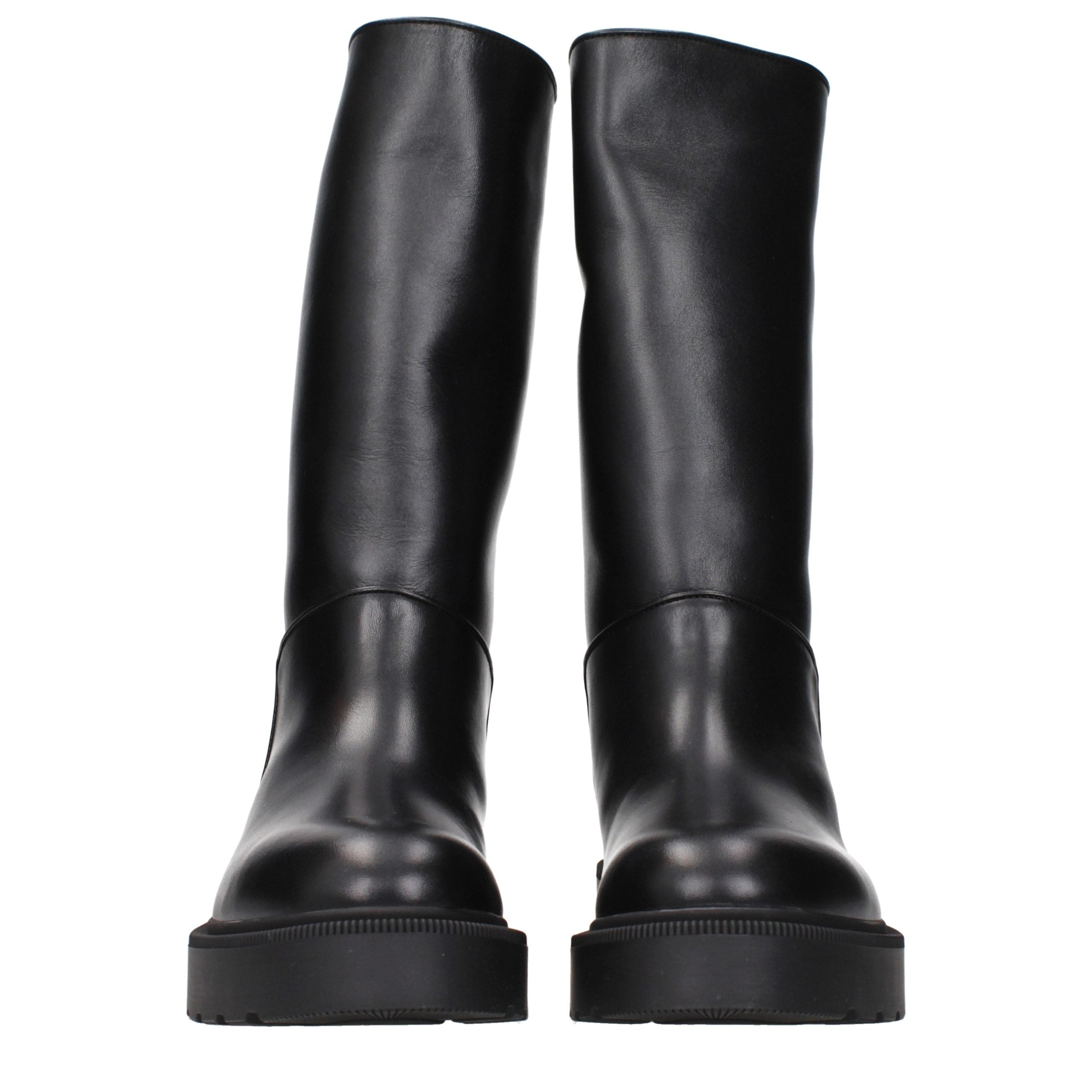 Step into a realm of sophistication with The Row Black Leather Boots, where artisanal craftsmanship meets timeless elegance, perfect for the discerning individual.