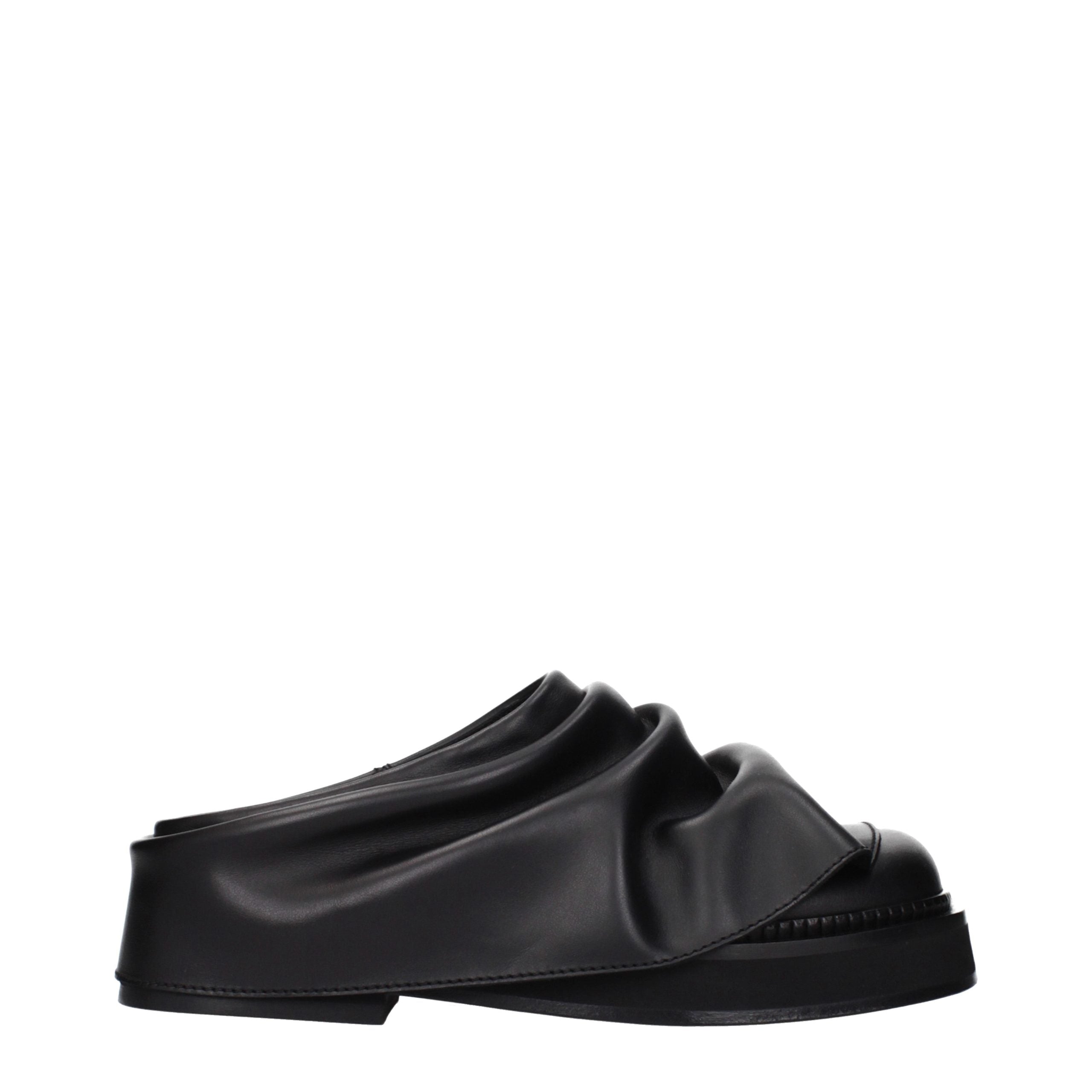 Step into timeless elegance with The Attico Black Leather Slippers, where exquisite craftsmanship meets luxurious comfort, perfect for the discerning individual.