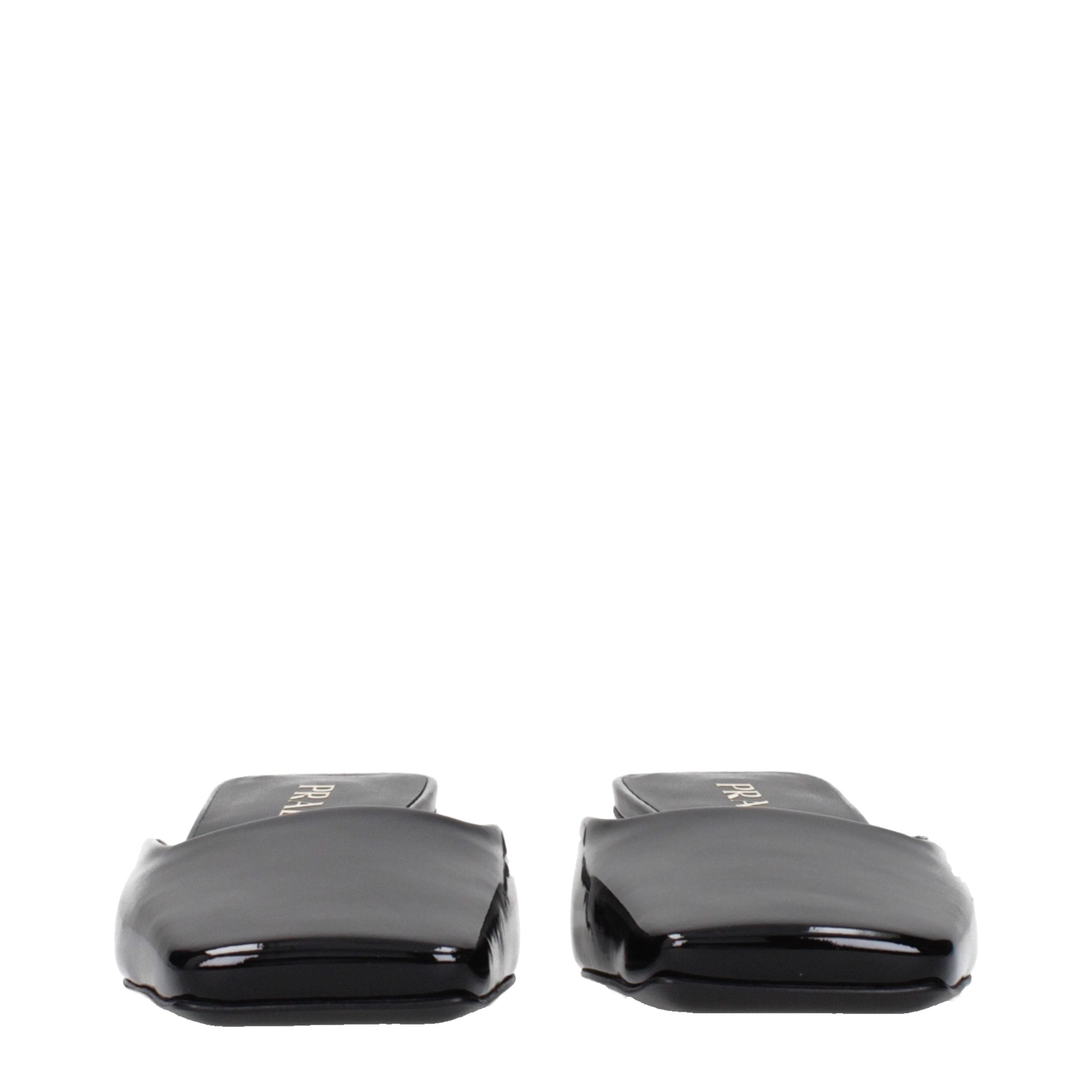 Experience the allure of Prada Black Leather Flat Sandals, where exquisite patent craftsmanship meets timeless elegance, perfect for the discerning individual.