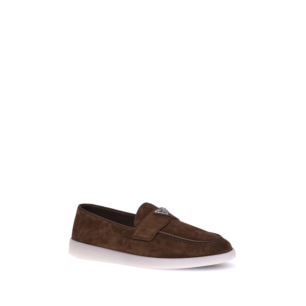 Elevate your style with Prada's Brown Calf Leather Bos Taurus Slip-On Loafers, a masterpiece of luxury craftsmanship that embodies timeless elegance and sophistication.