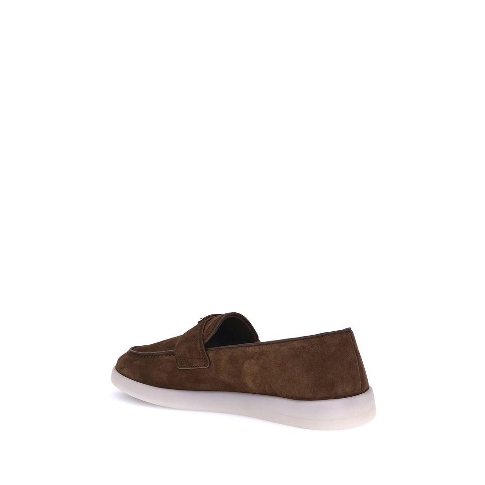 Experience the allure of Prada's Brown Calf Leather Bos Taurus Slip-On Loafers, where exquisite craftsmanship meets timeless elegance for the discerning individual.