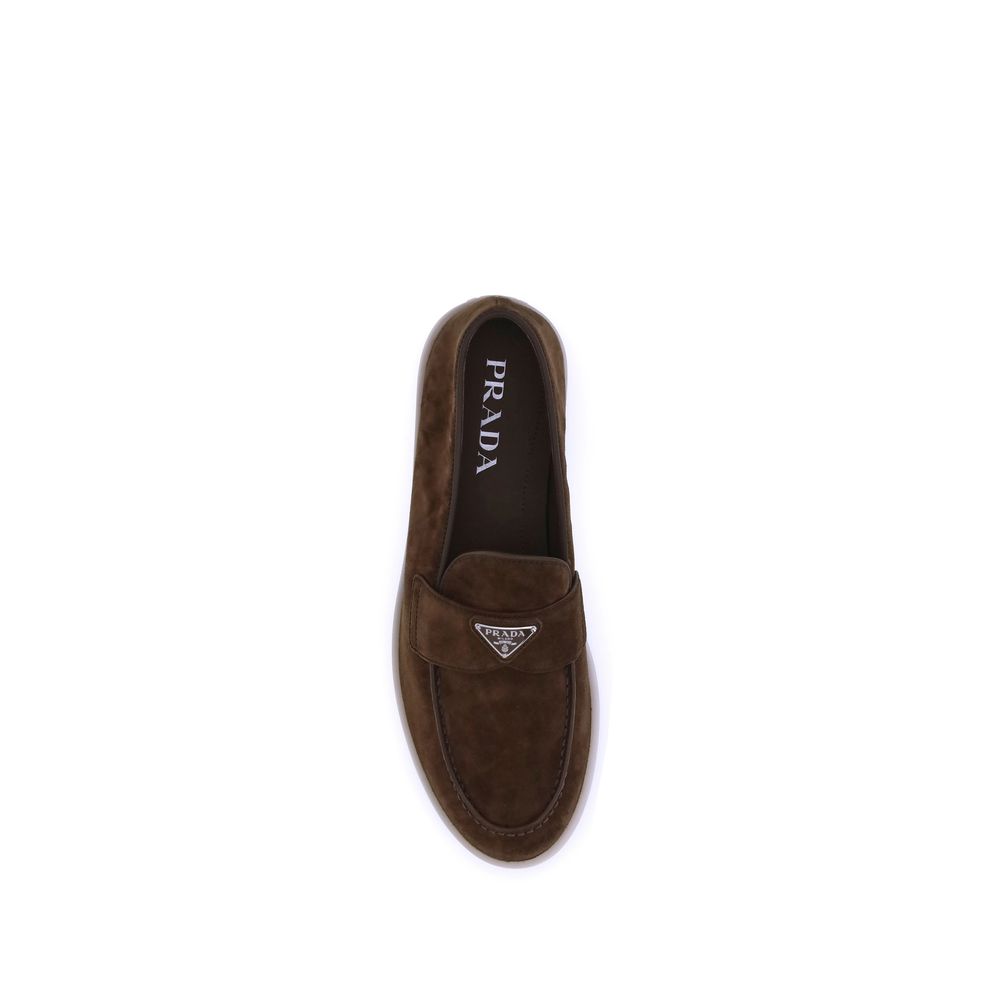 Experience the allure of Prada's Brown Calf Leather Bos Taurus Slip-On Loafers, where exquisite craftsmanship meets timeless elegance, perfect for the discerning individual.