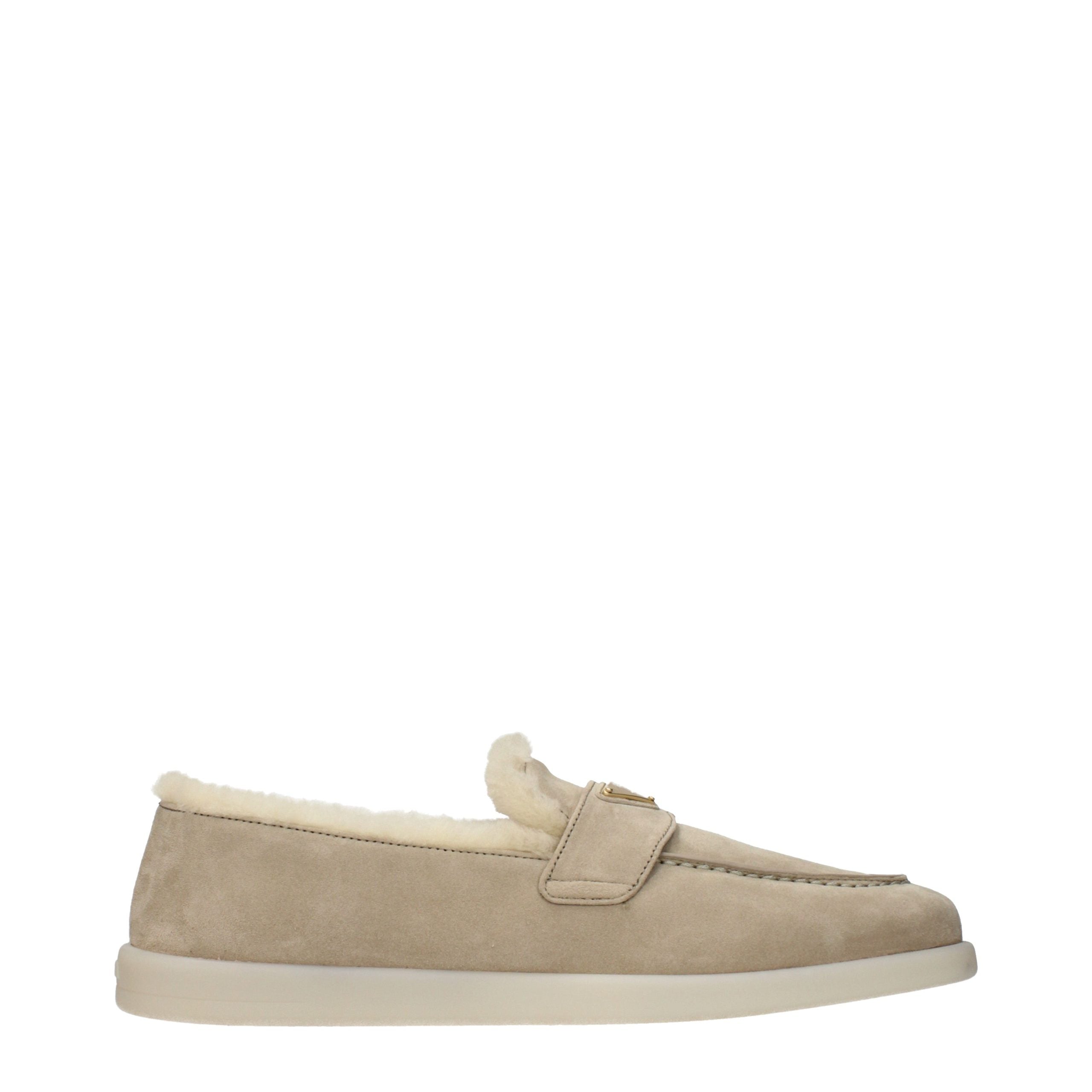 Indulge in Prada's Beige Leather Slip-On Loafers, where sumptuous suede meets exquisite craftsmanship, embodying timeless elegance for the discerning individual.
