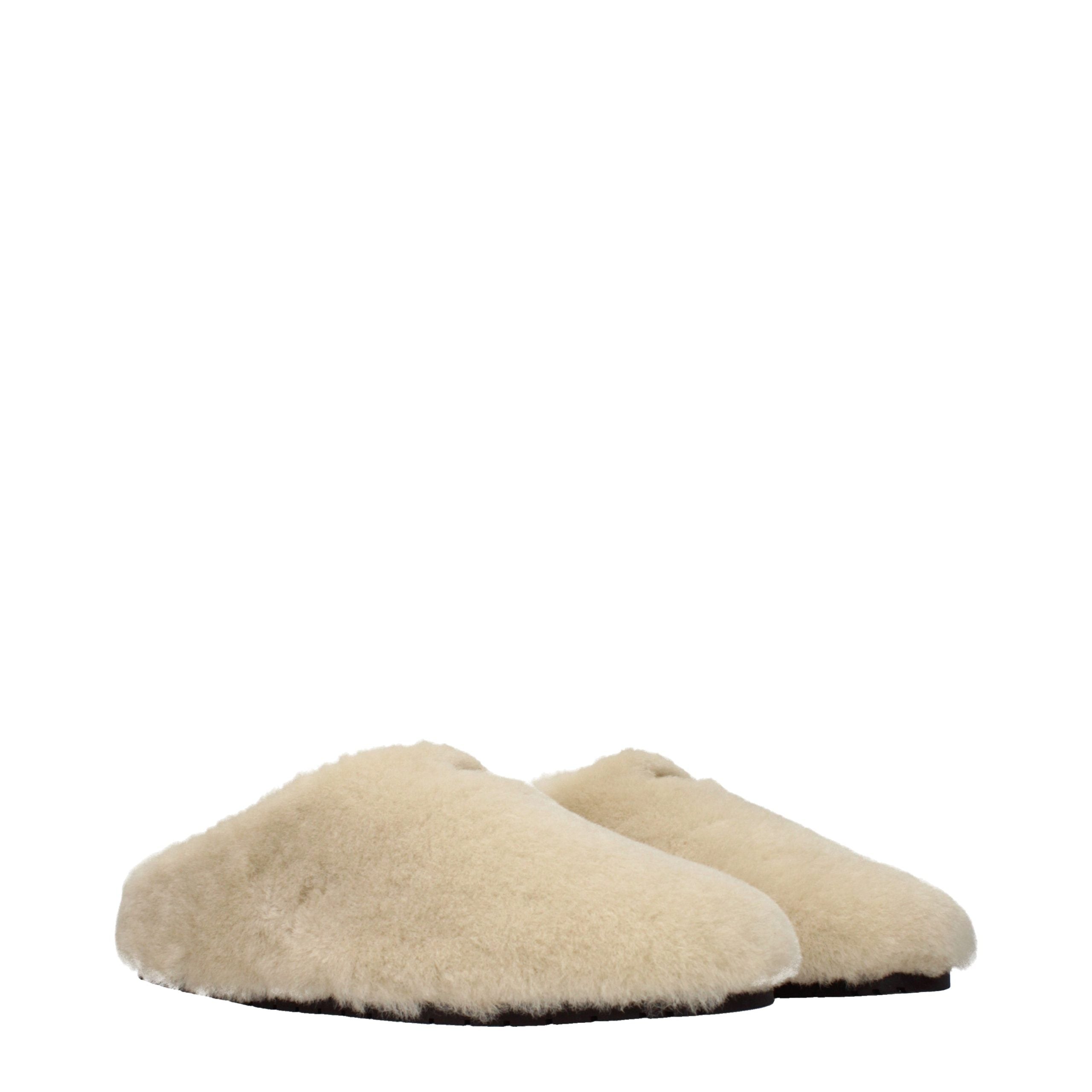 Indulge in the exquisite allure of Prada Beige Fur Slippers, where artisanal craftsmanship meets luxurious comfort, elevating your everyday elegance with timeless sophistication.
