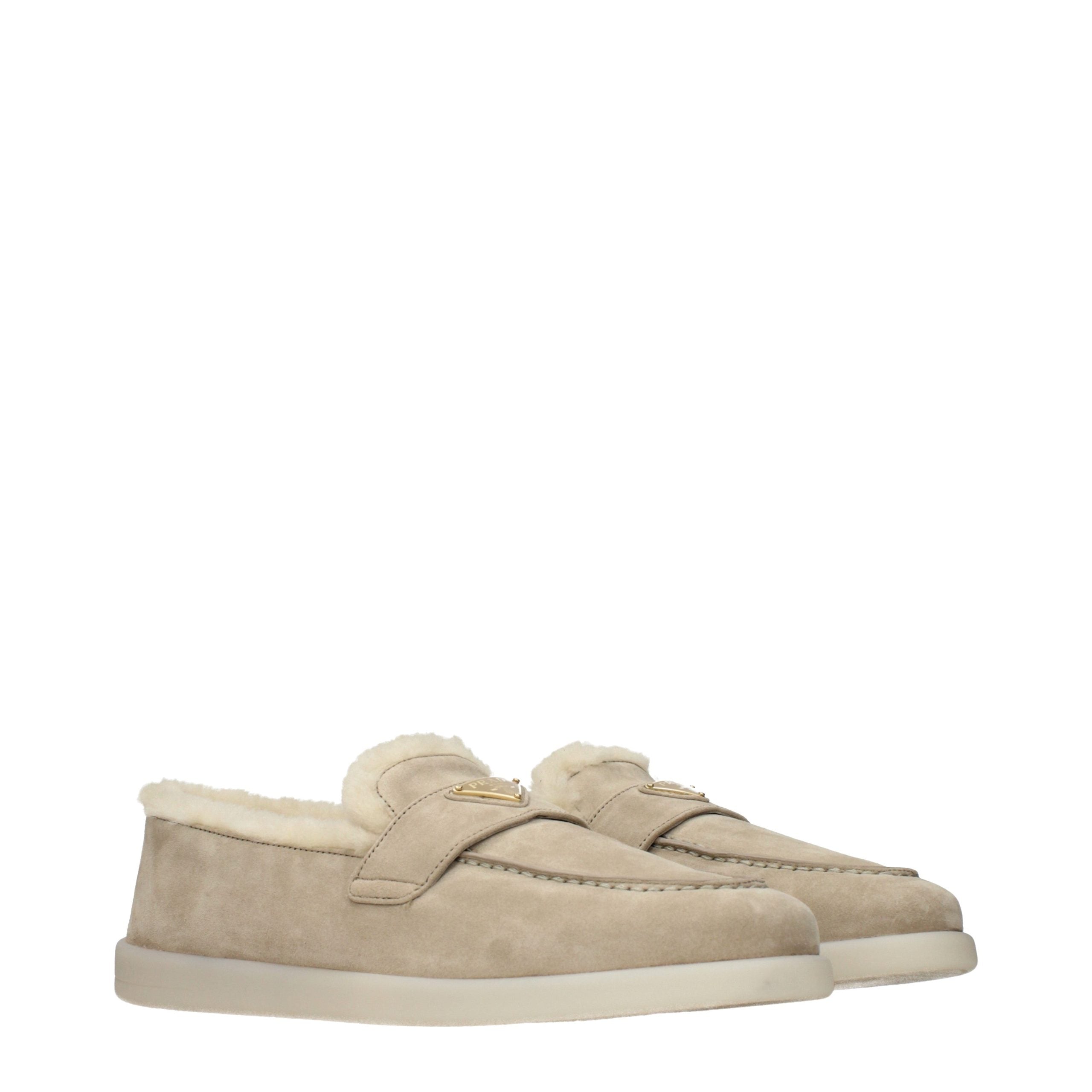 Experience the allure of Prada's Beige Leather Slip-On Loafers, where sumptuous suede meets exquisite craftsmanship, embodying timeless elegance for the discerning individual.