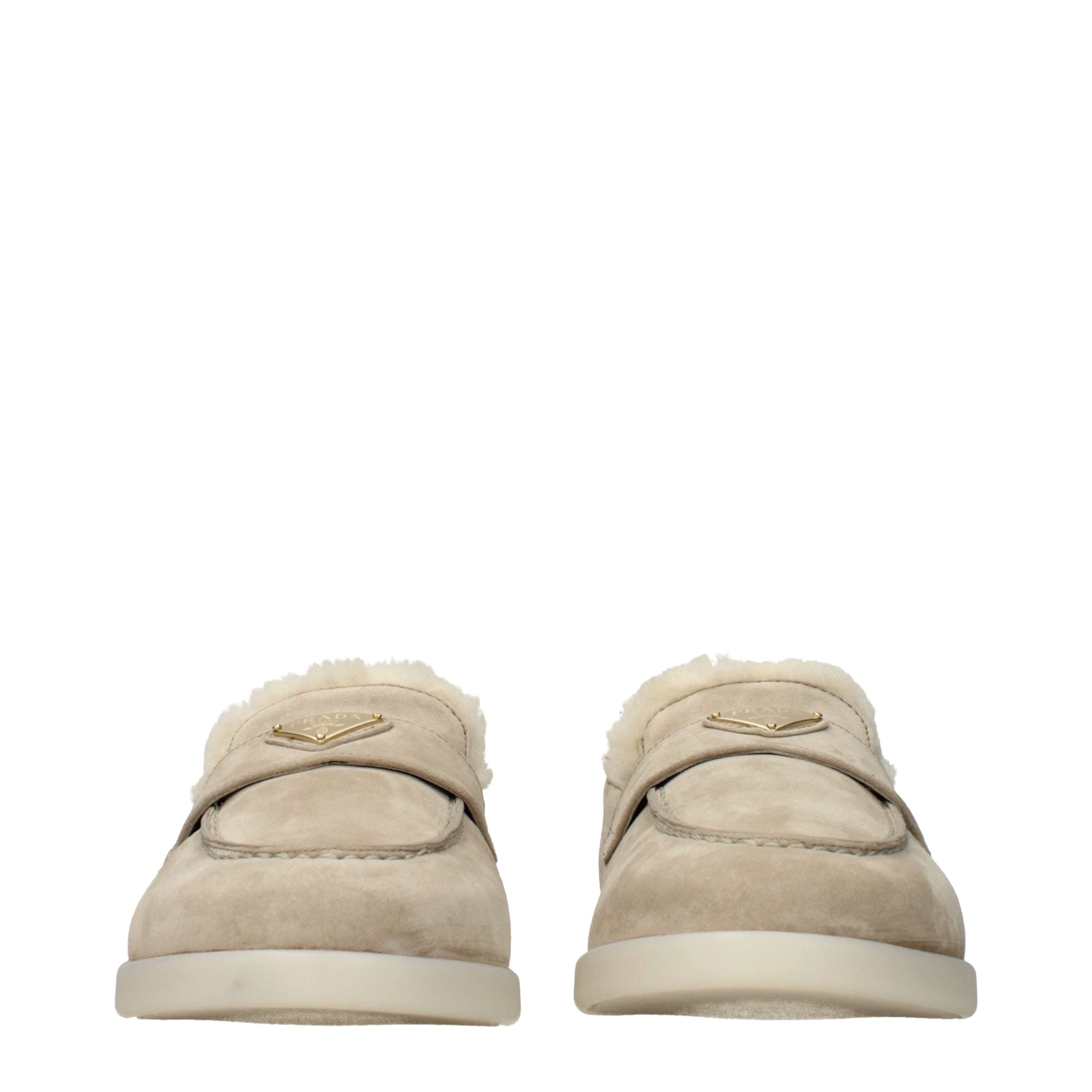 Discover the exquisite Prada Beige Leather Slip-On Loafers, where sumptuous suede meets unparalleled craftsmanship, elevating your elegance with every step.