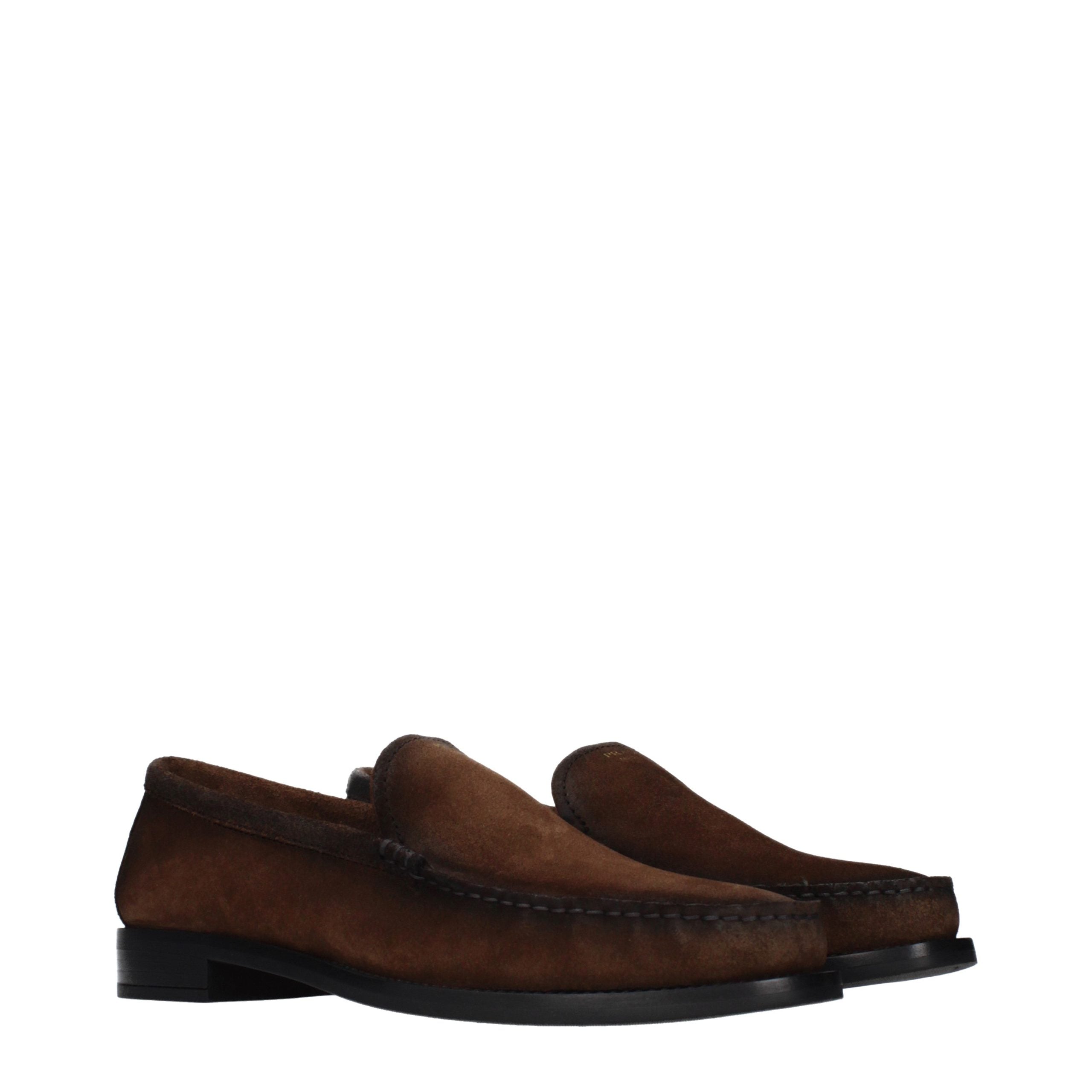 Experience the allure of Prada's Brown Leather Slip-On Loafers, where artisanal craftsmanship meets timeless elegance, perfect for the discerning individual.