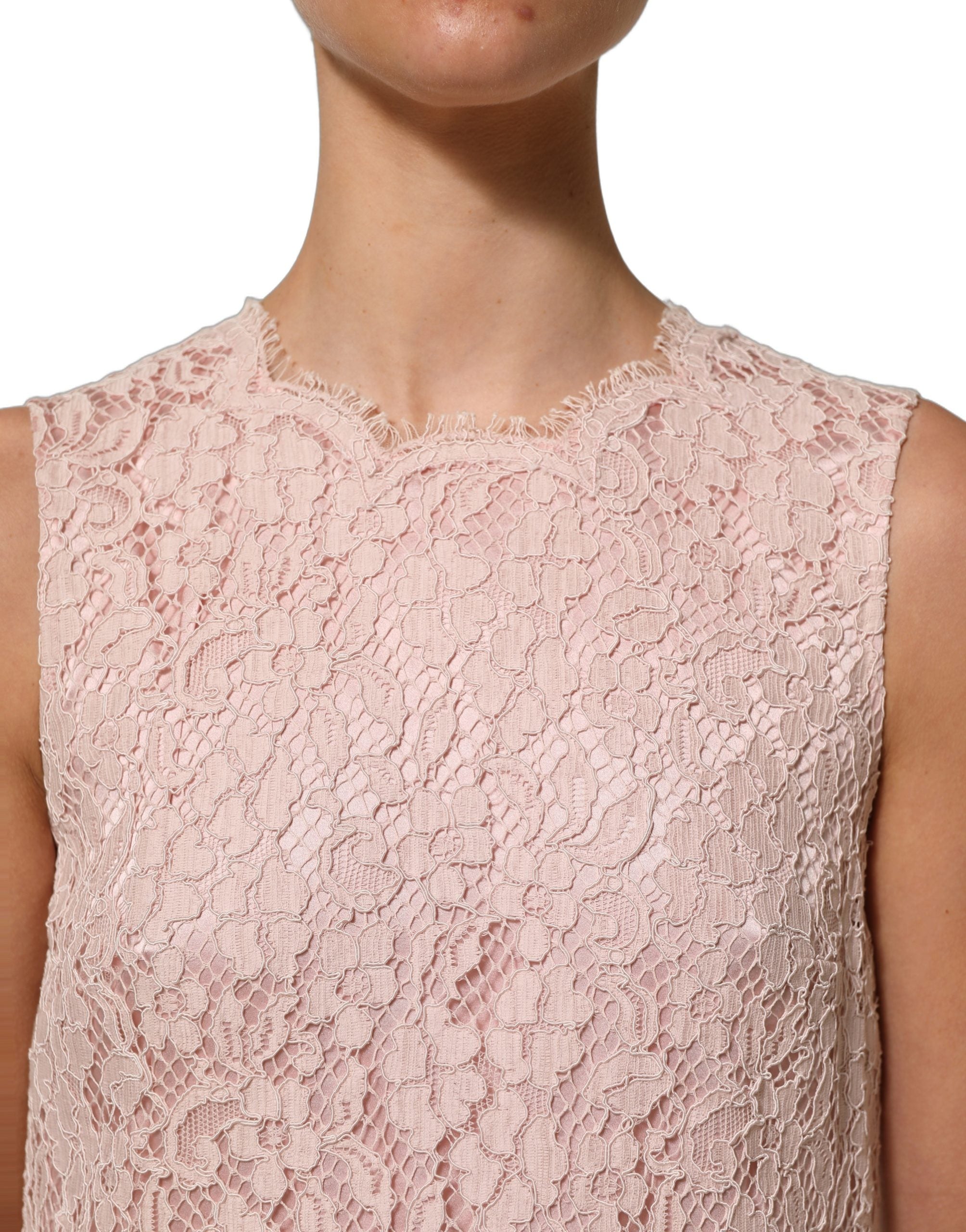Experience the exquisite allure of Dolce & Gabbana's Pink Cotton Floral Lace Mini Dress, a masterpiece of Italian craftsmanship that embodies timeless elegance and sophistication.