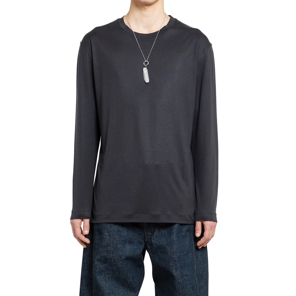 Elevate your wardrobe with the Lemaire Black Silk T-Shirt, a luxurious blend of 100% silk and artisanal craftsmanship, embodying sophistication for the discerning individual.