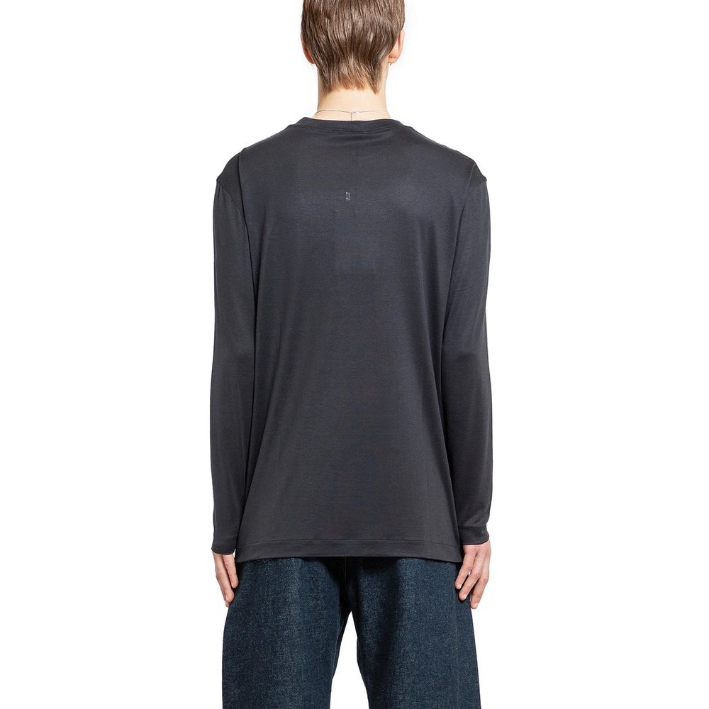 Discover the Lemaire Black Silk T-Shirt, a luxurious essential crafted from 100% silk in Portugal, embodying sophistication and timeless elegance for the discerning individual.