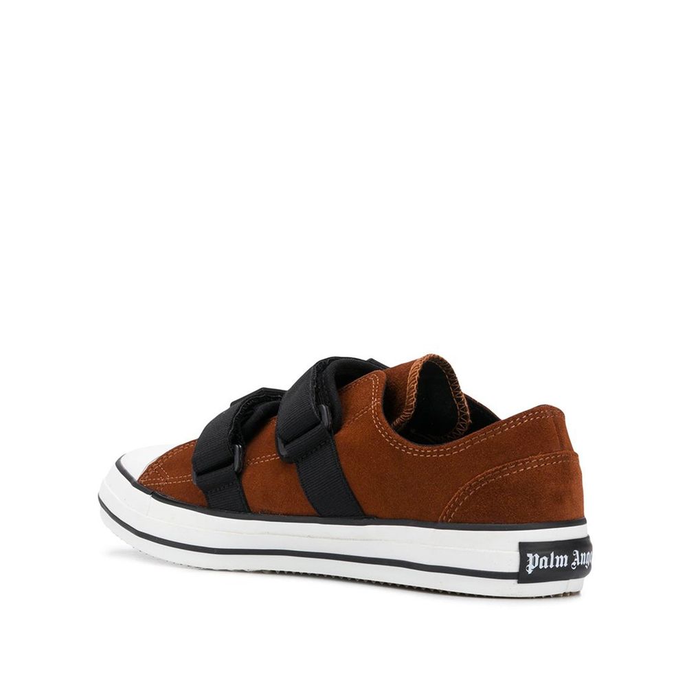 Experience the allure of Palm Angels Brown Calfskin Low Top Sneakers, where exquisite craftsmanship meets timeless luxury, elevating your style with every step.