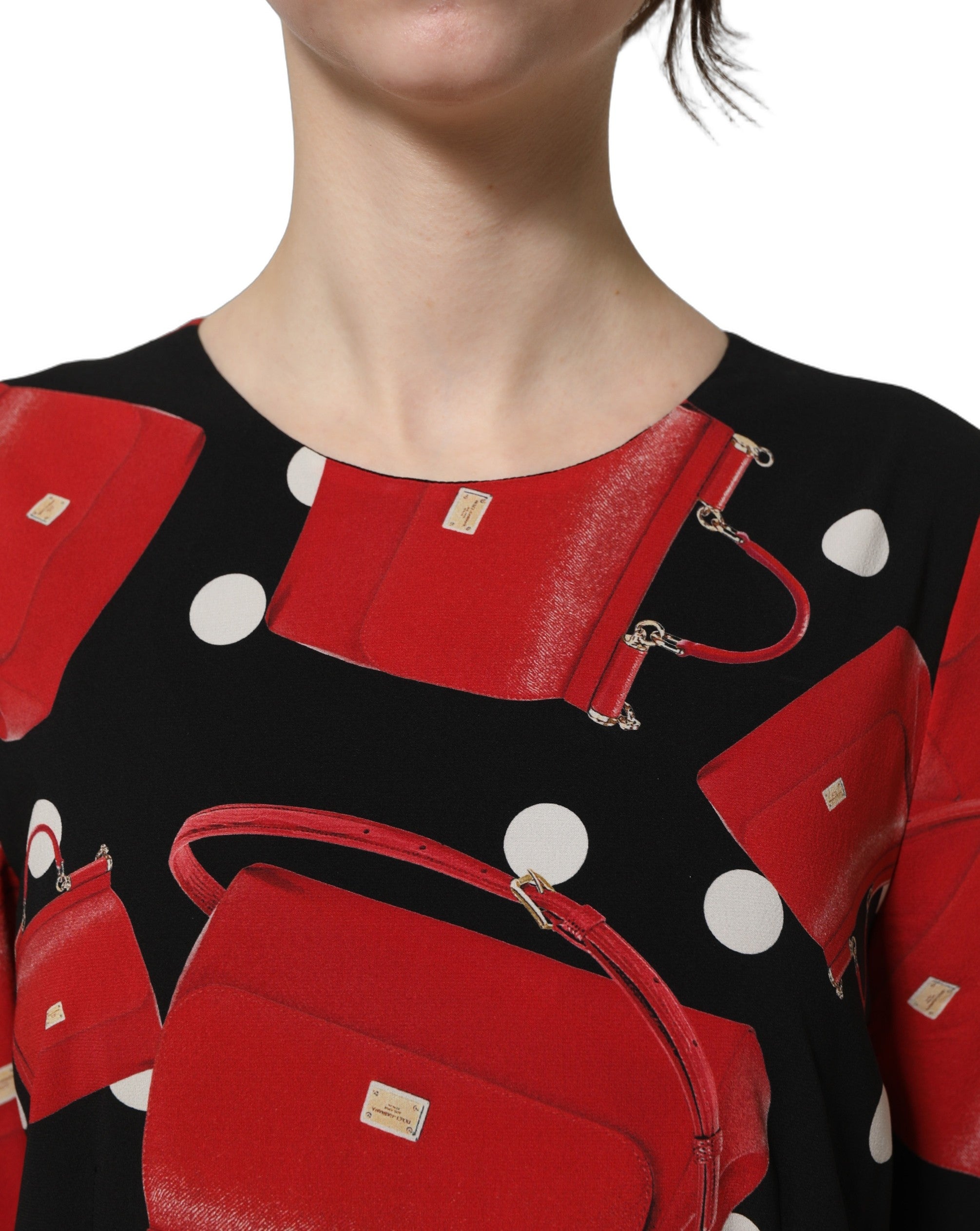 Experience the allure of Dolce & Gabbana's Black Handbag Print Long Sleeve Midi Dress, crafted from luxurious silk for a timeless statement of elegance and sophistication.