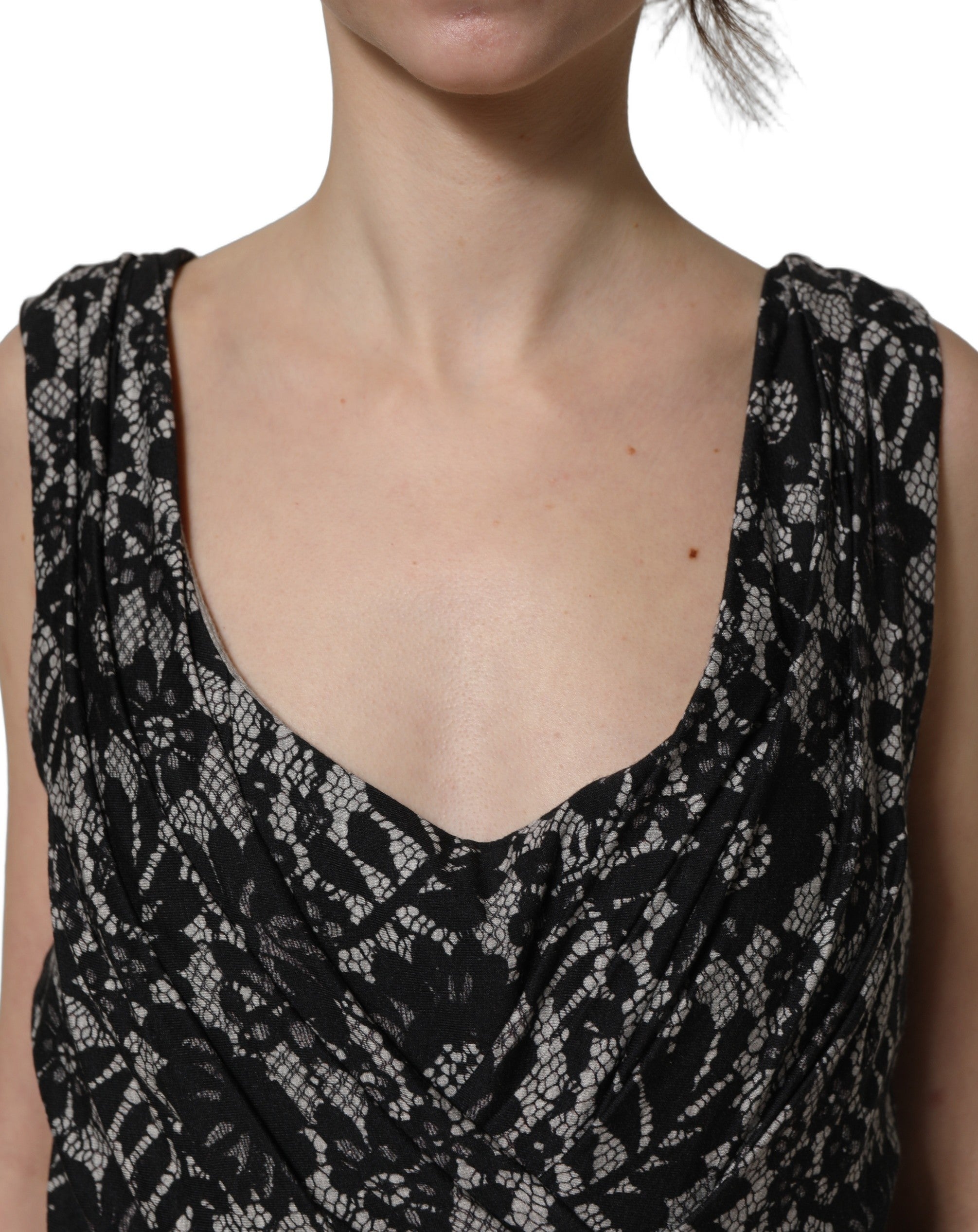 Elevate your style with the Dolce & Gabbana Black White Floral Lace Sleeveless Midi Dress, a masterpiece of Italian craftsmanship that embodies timeless elegance and sophistication.