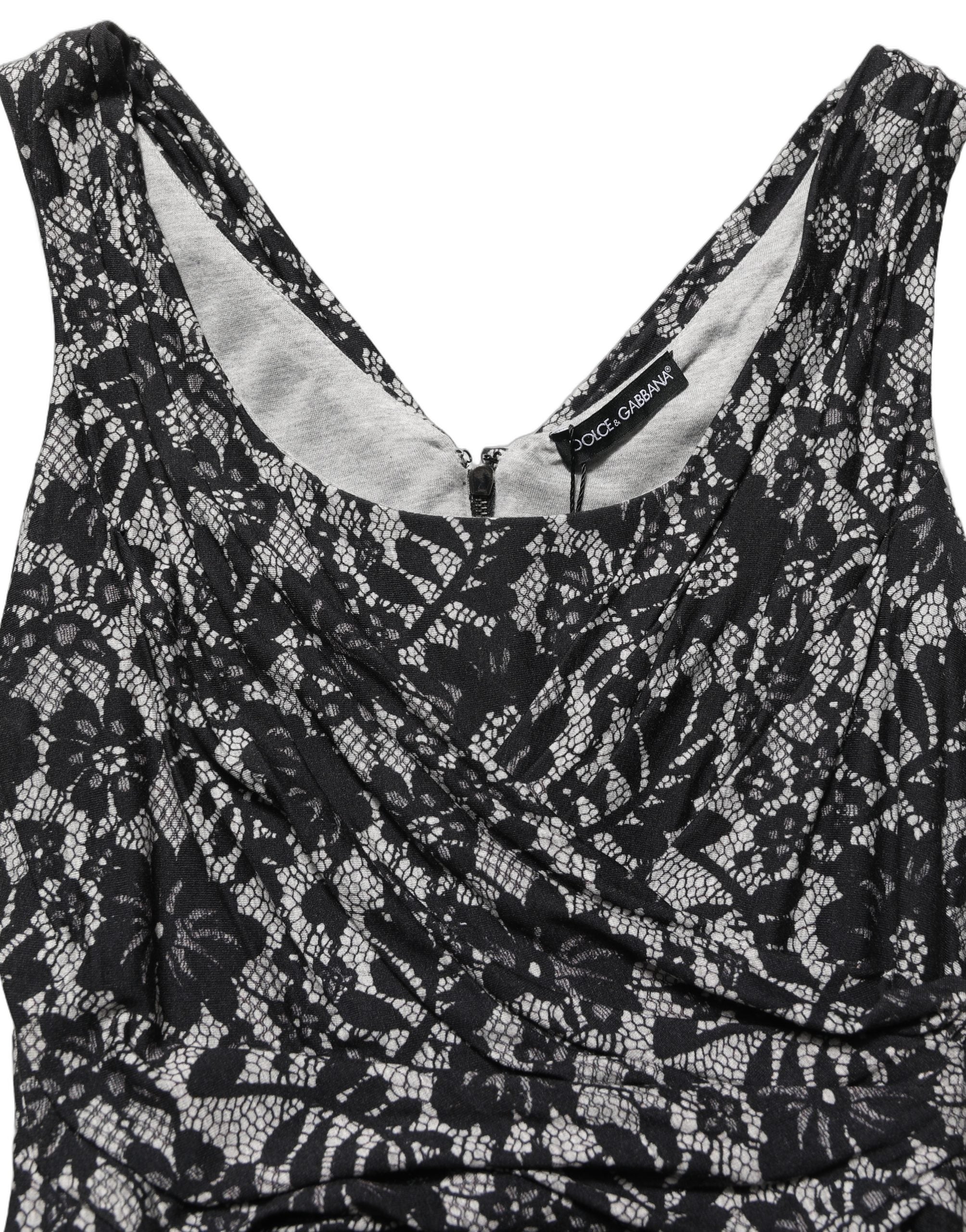 Indulge in the exquisite Dolce & Gabbana Black White Floral Lace Sleeveless Midi Dress, a masterpiece of Italian craftsmanship that embodies timeless elegance and allure.