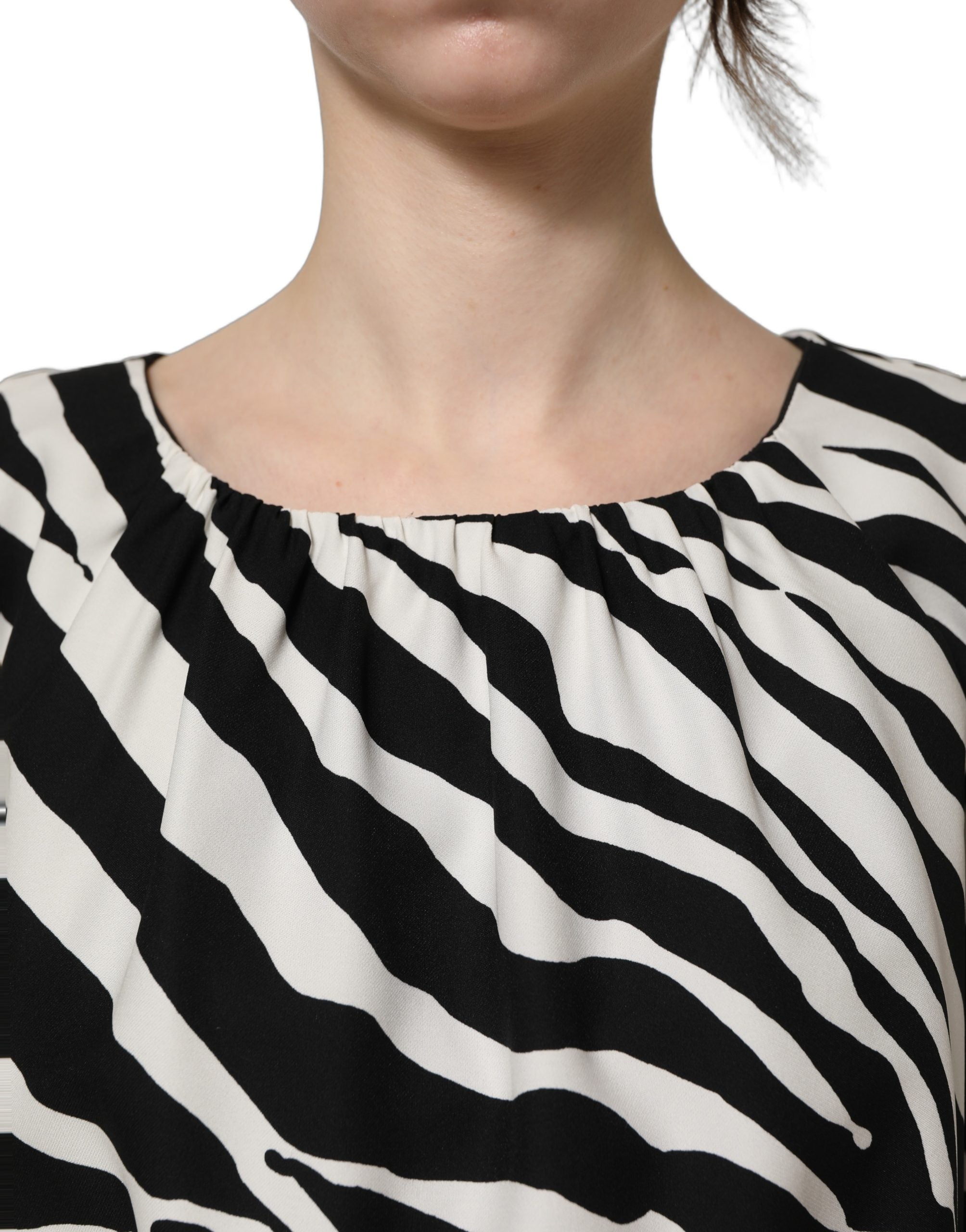 Discover the Dolce & Gabbana Black White Zebra Ruched Silk Mini Dress, a luxurious blend of silk and elastane, embodying exquisite Italian craftsmanship and timeless elegance.
