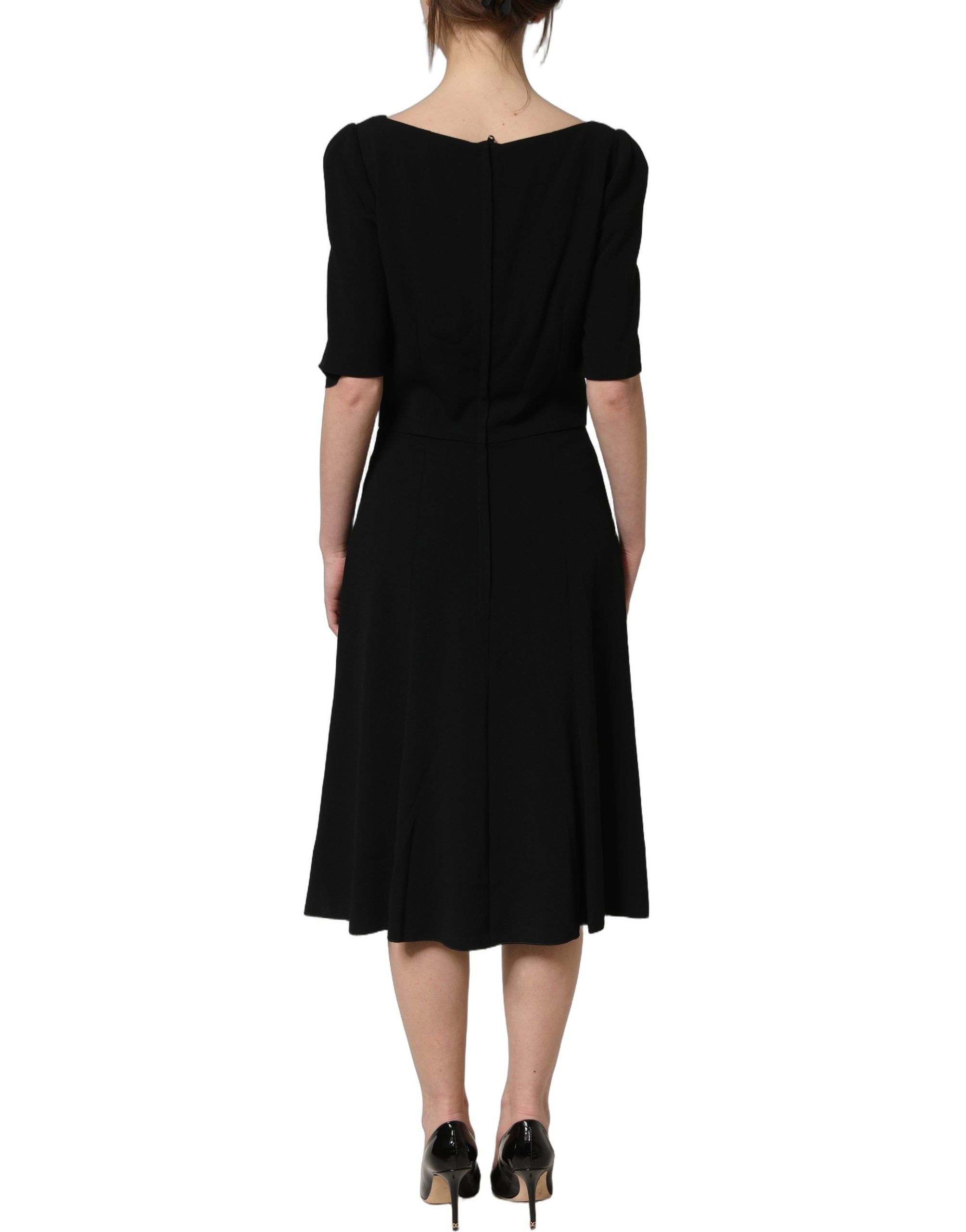 Discover the exquisite allure of Dolce & Gabbana's Black Viscose Short Sleeve A-line Midi Dress, a masterpiece of luxury craftsmanship that embodies timeless elegance and sophistication.