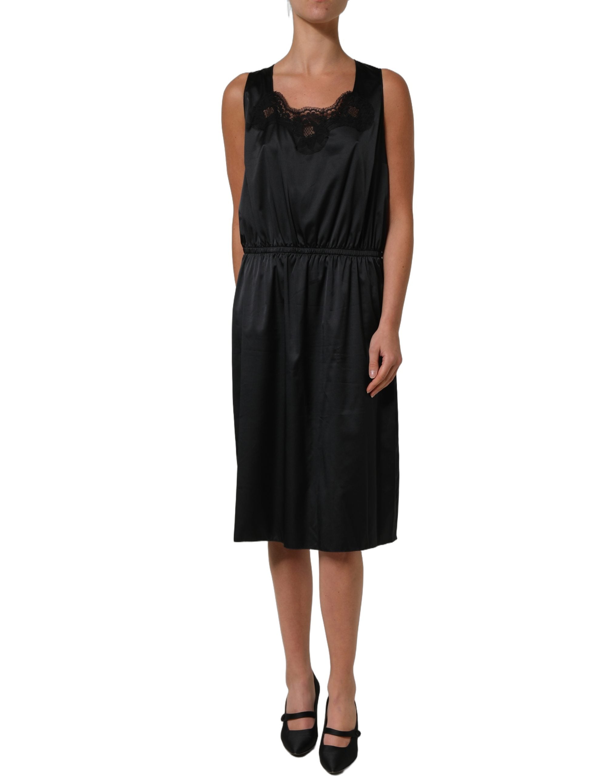 Experience the exquisite allure of the Dolce & Gabbana Black Lace Trim Midi Dress, a timeless masterpiece crafted from luxurious materials, perfect for any sophisticated occasion.