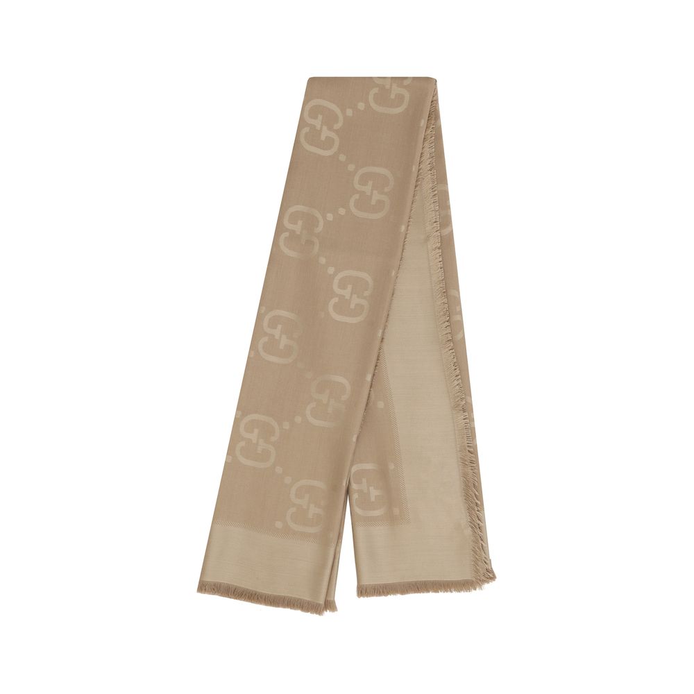 Indulge in the elegance of the Gucci Brown Wool Oves Aries Foulard, crafted from luxurious wool and silk, embodying sophistication with its iconic GG pattern and artisanal frayed edges.