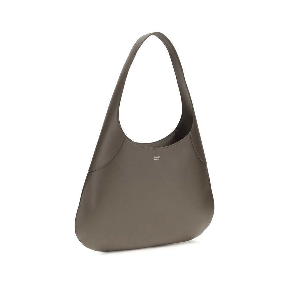 Discover the Khaite Gray Calf Leather Bos Taurus Handbag, a masterpiece of artisanal elegance and sophisticated design, perfect for the discerning individual.