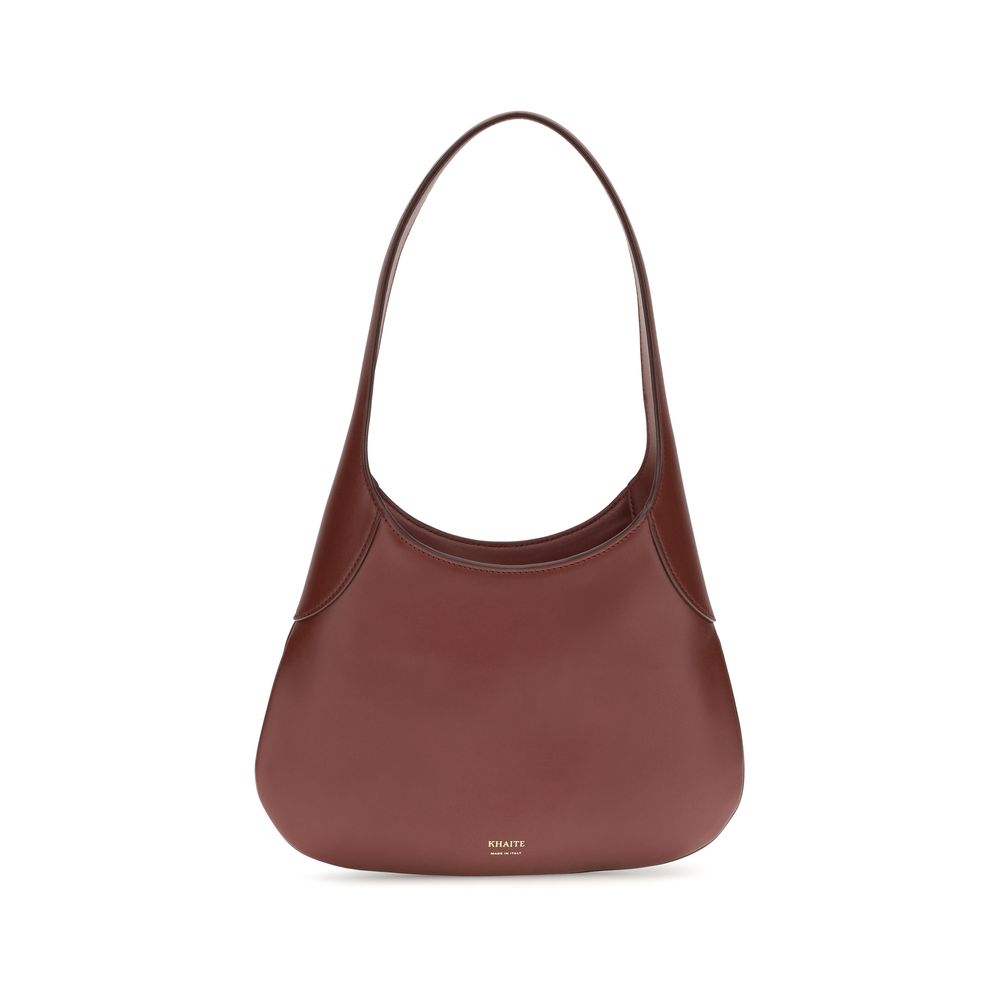 Indulge in the Khaite Bordeaux Calf Leather Bos Taurus Handbag, a masterpiece of artisanal elegance crafted from sumptuous calfskin, perfect for the discerning connoisseur.