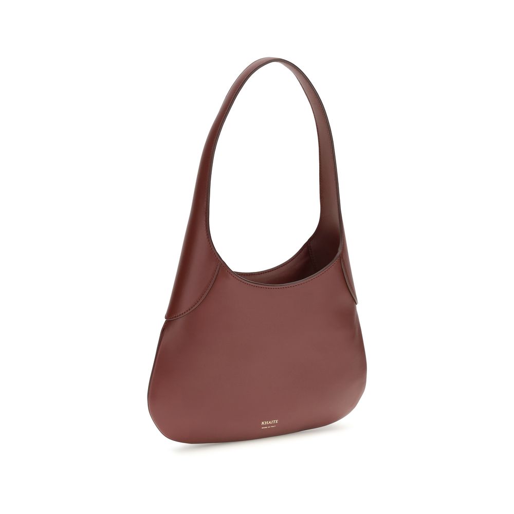 Discover the Khaite Bordeaux Calf Leather Bos Taurus Handbag, a symbol of artisanal elegance, crafted from luxurious calfskin for the discerning individual.